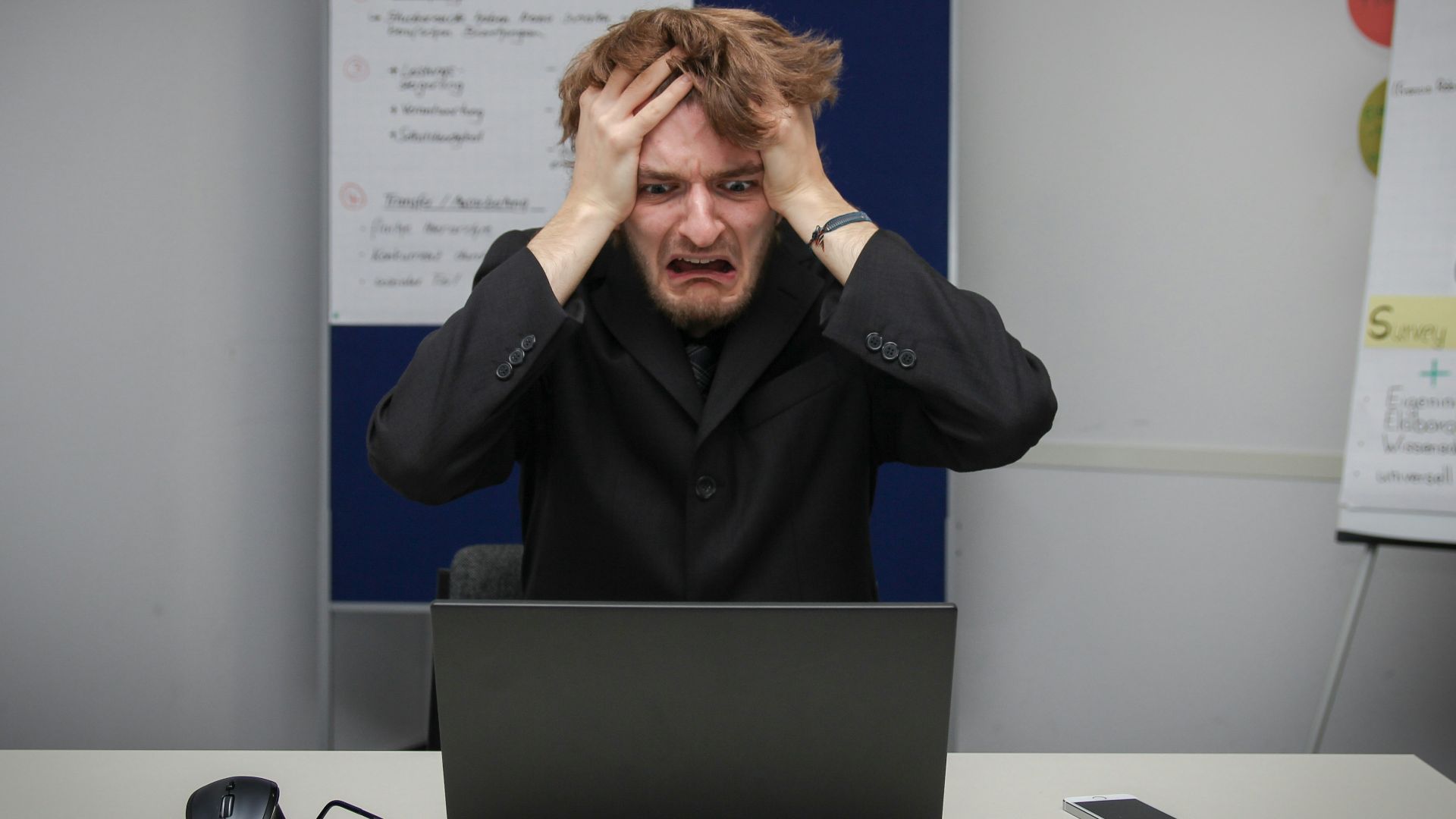 A man sitting in front of a laptop computer