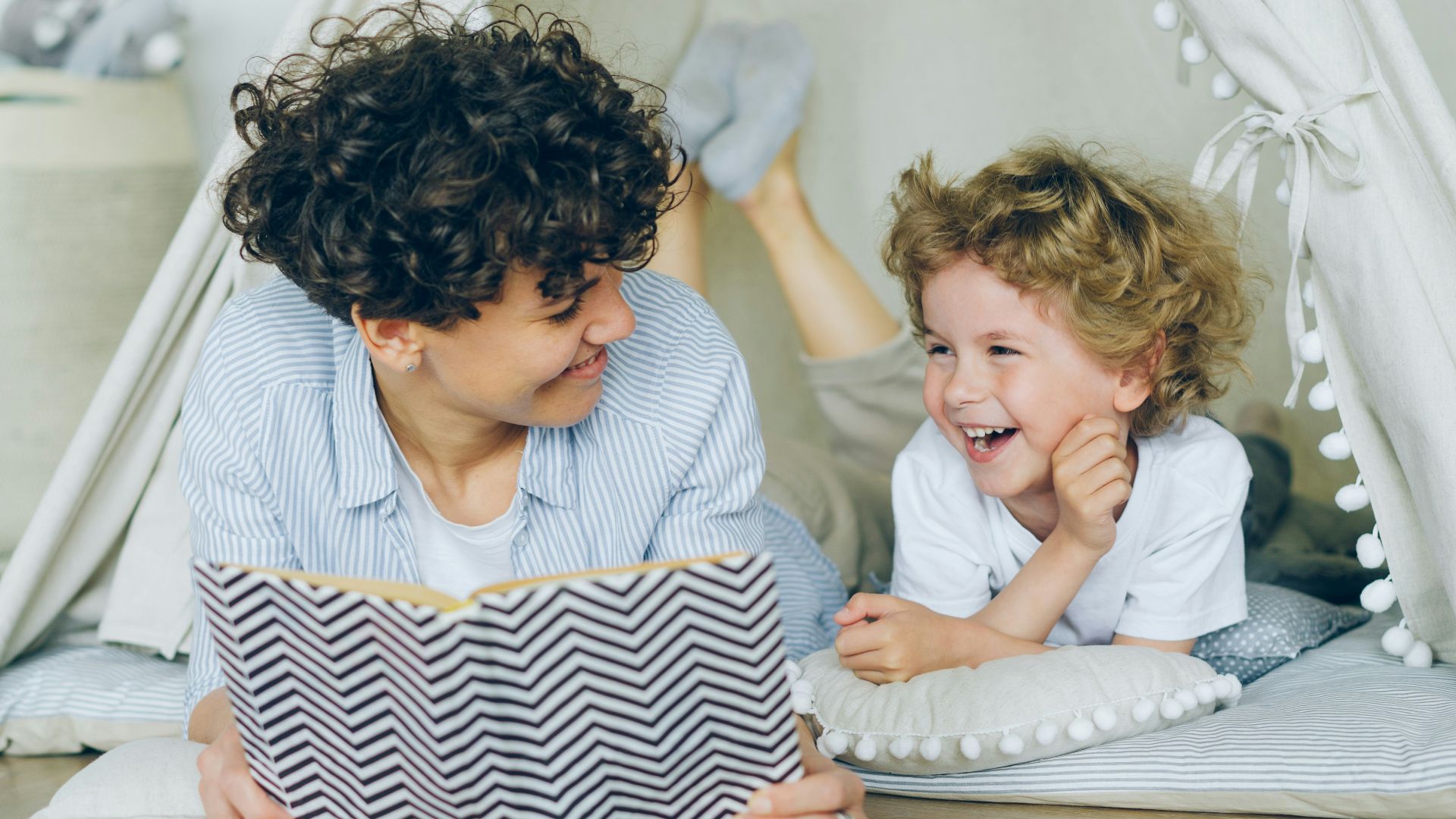 a woman reading a book to a child