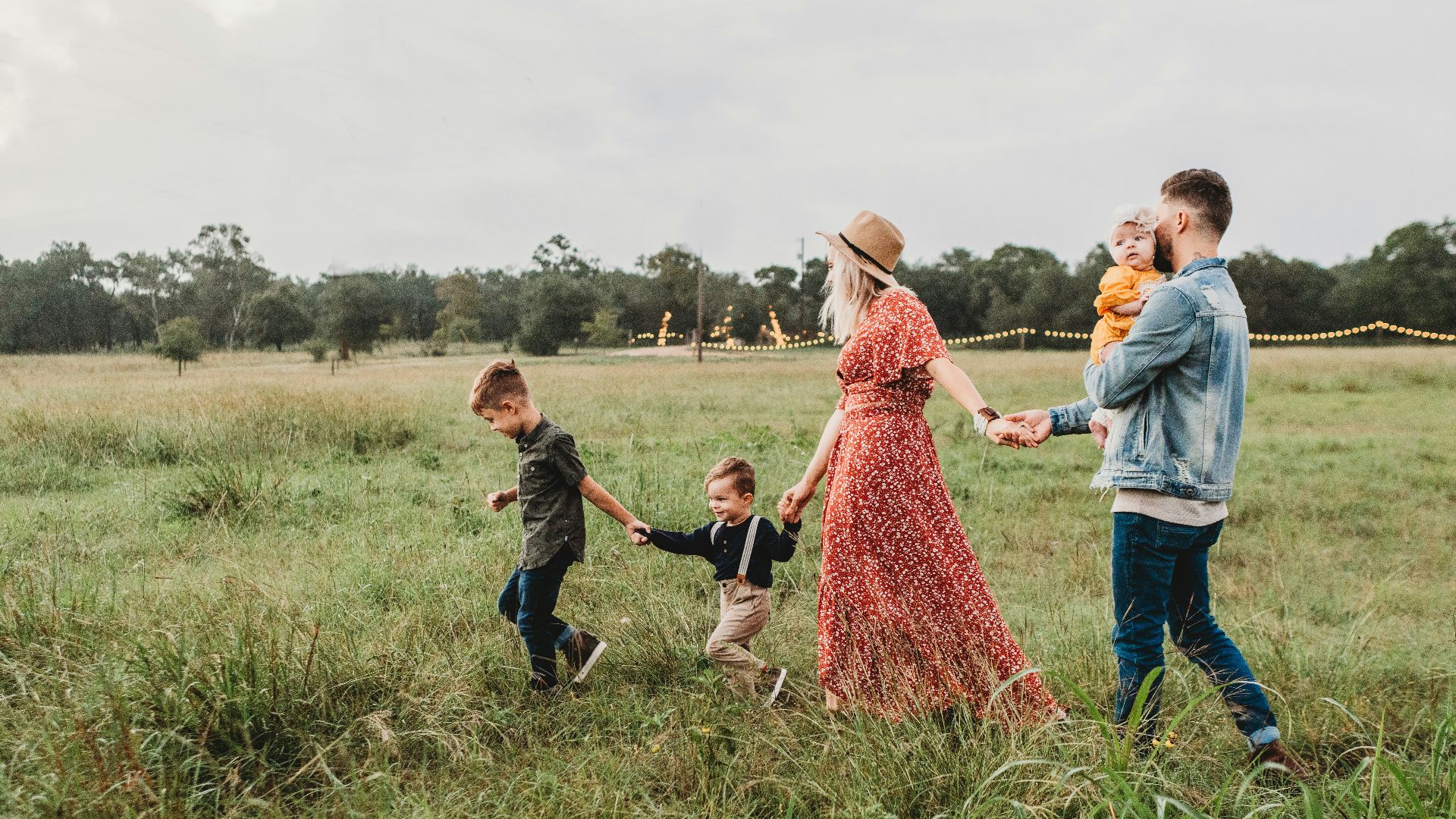 woman holding man and toddler hands during daytime