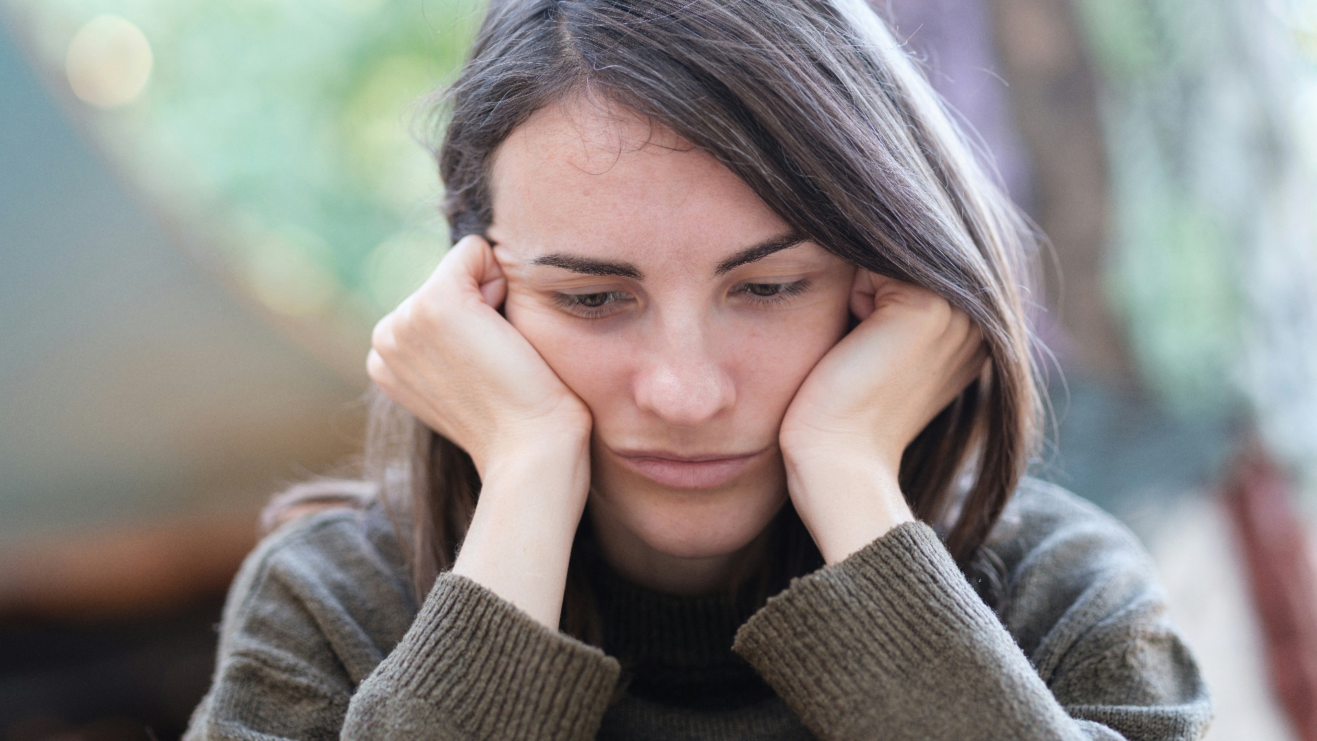 a woman holding her head in her hands