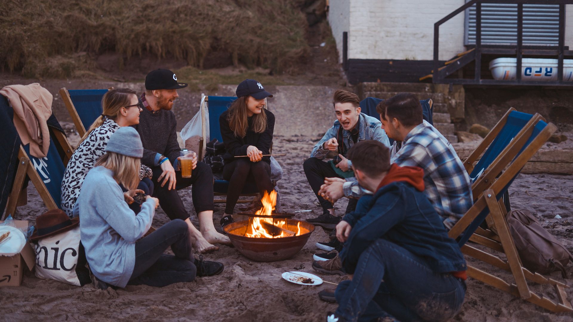 group of people sitting on front firepit