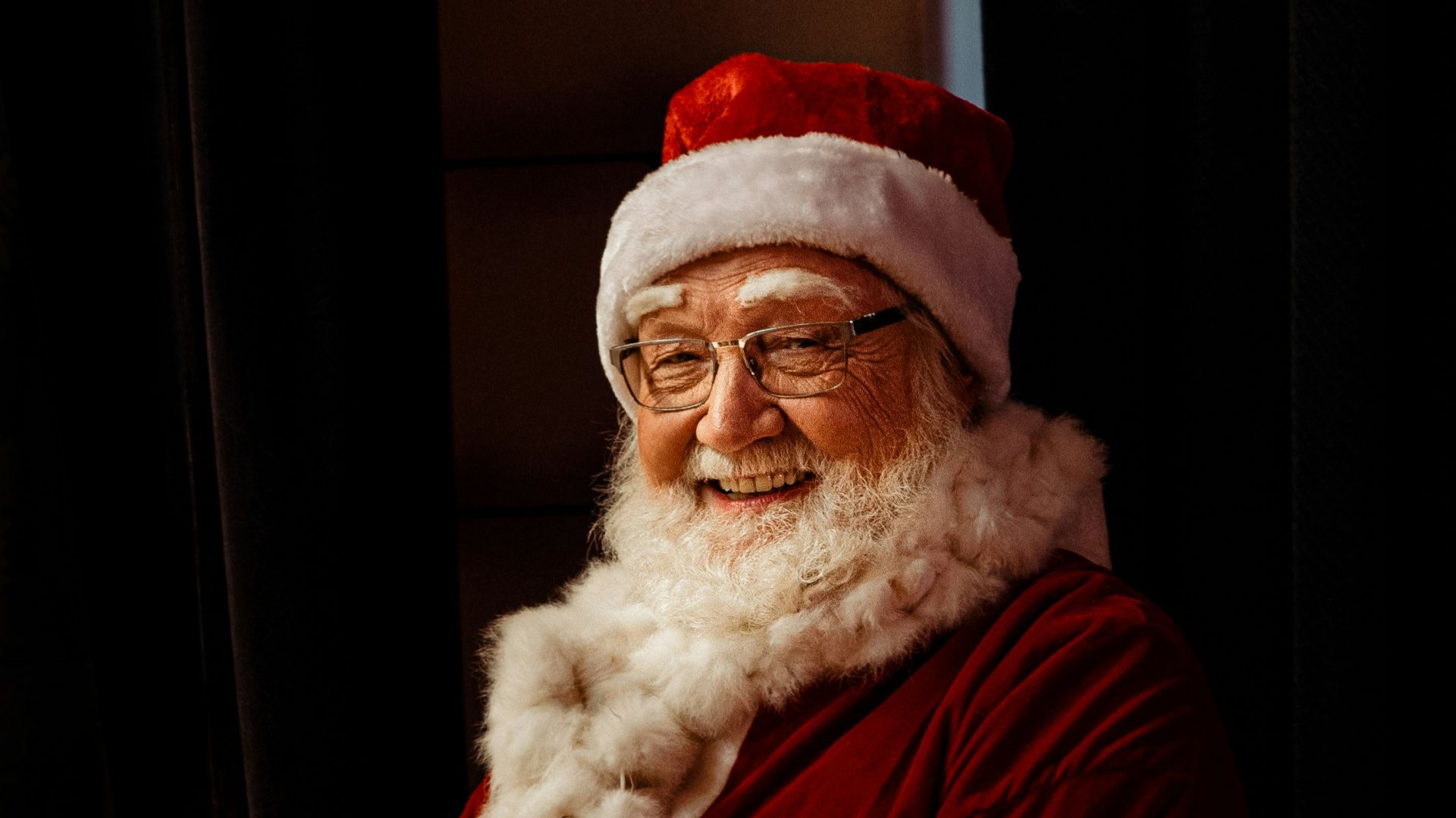 a man dressed as santa claus sitting in a chair