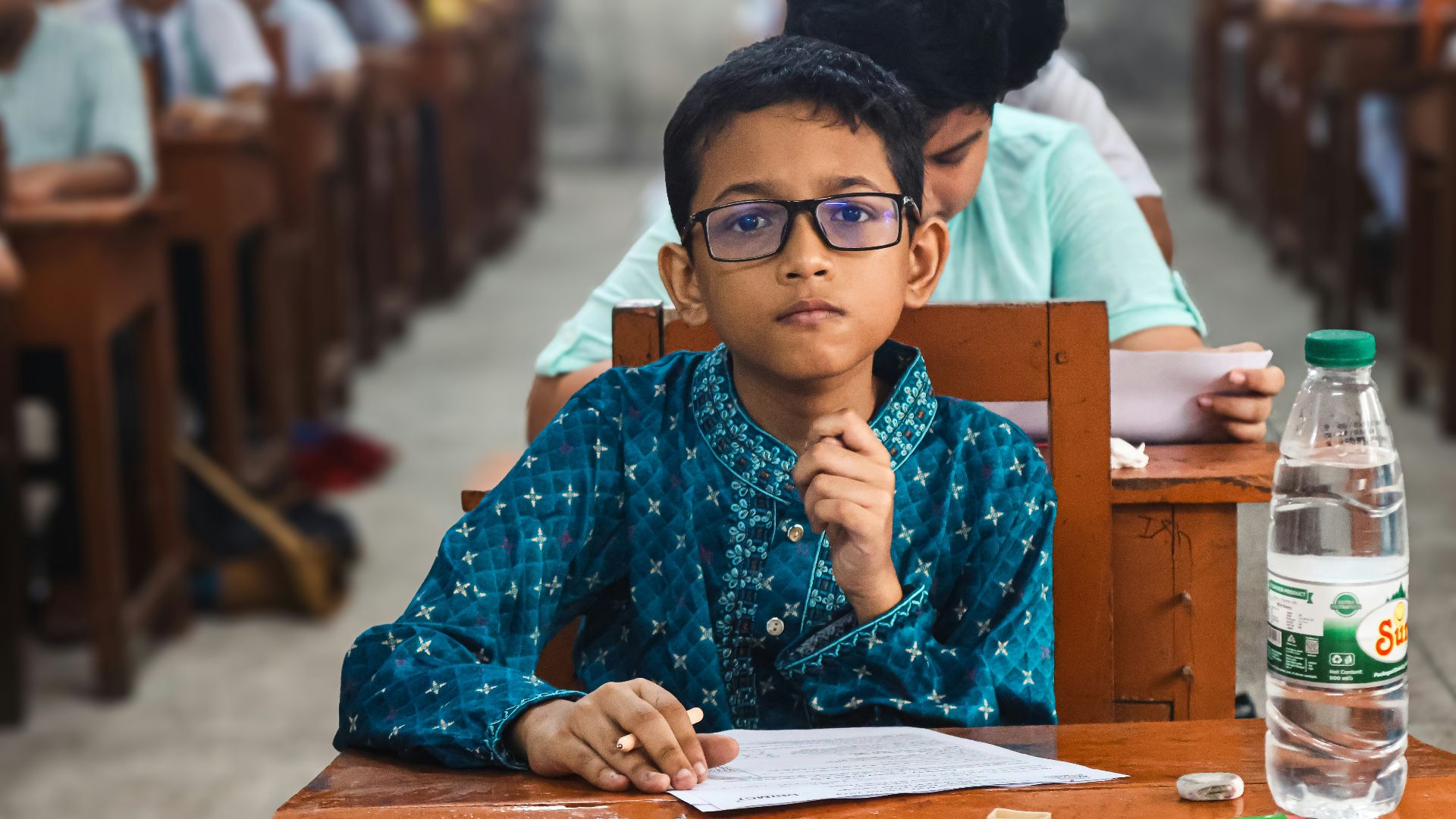 Young boy wearing glasses takes a test