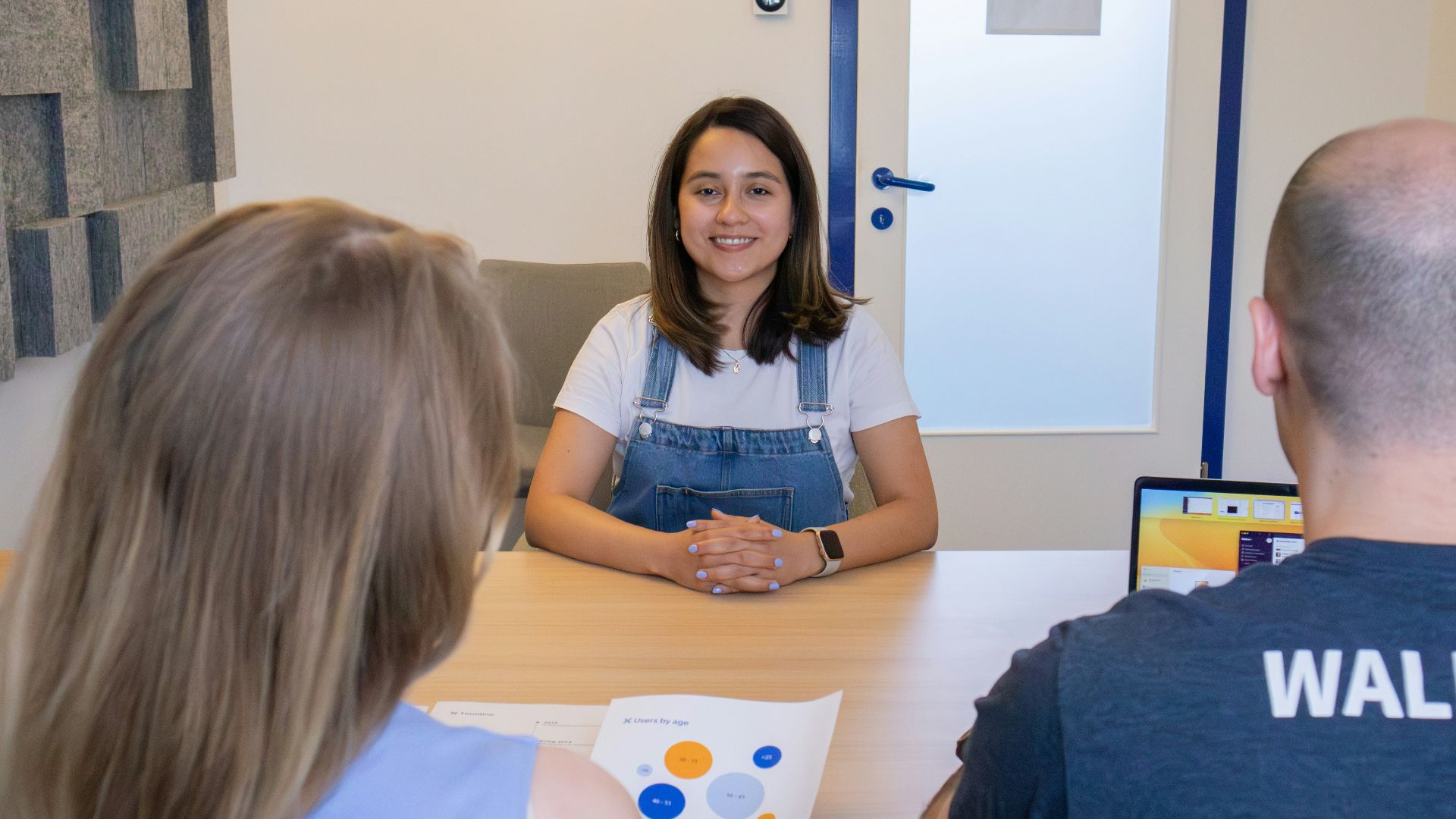 a woman sitting at a table in front of a man