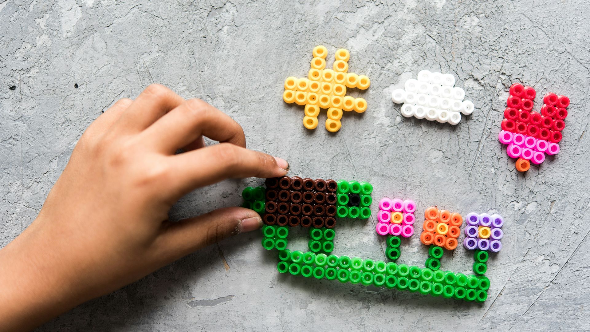 a hand is holding a piece of lego art