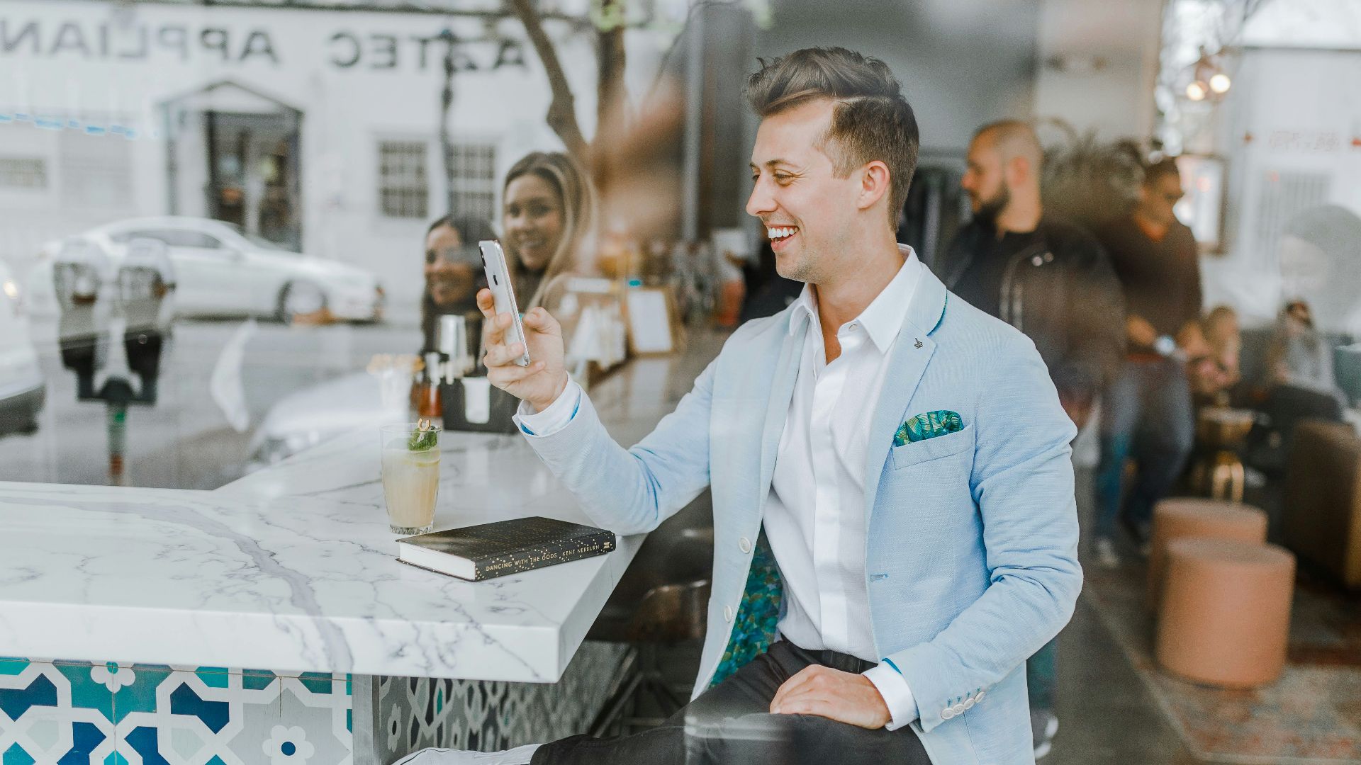 smiling man while holding smartphone