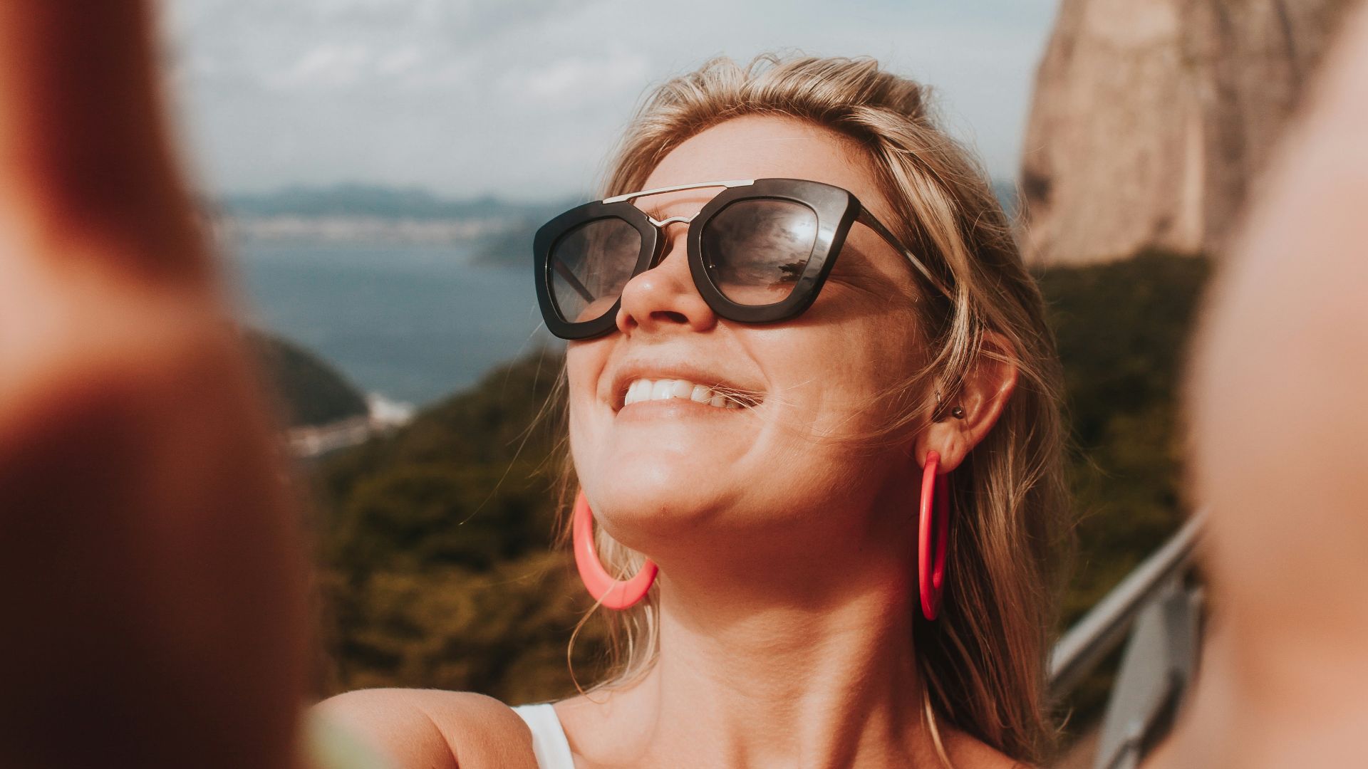 woman in white tank top wearing black sunglasses