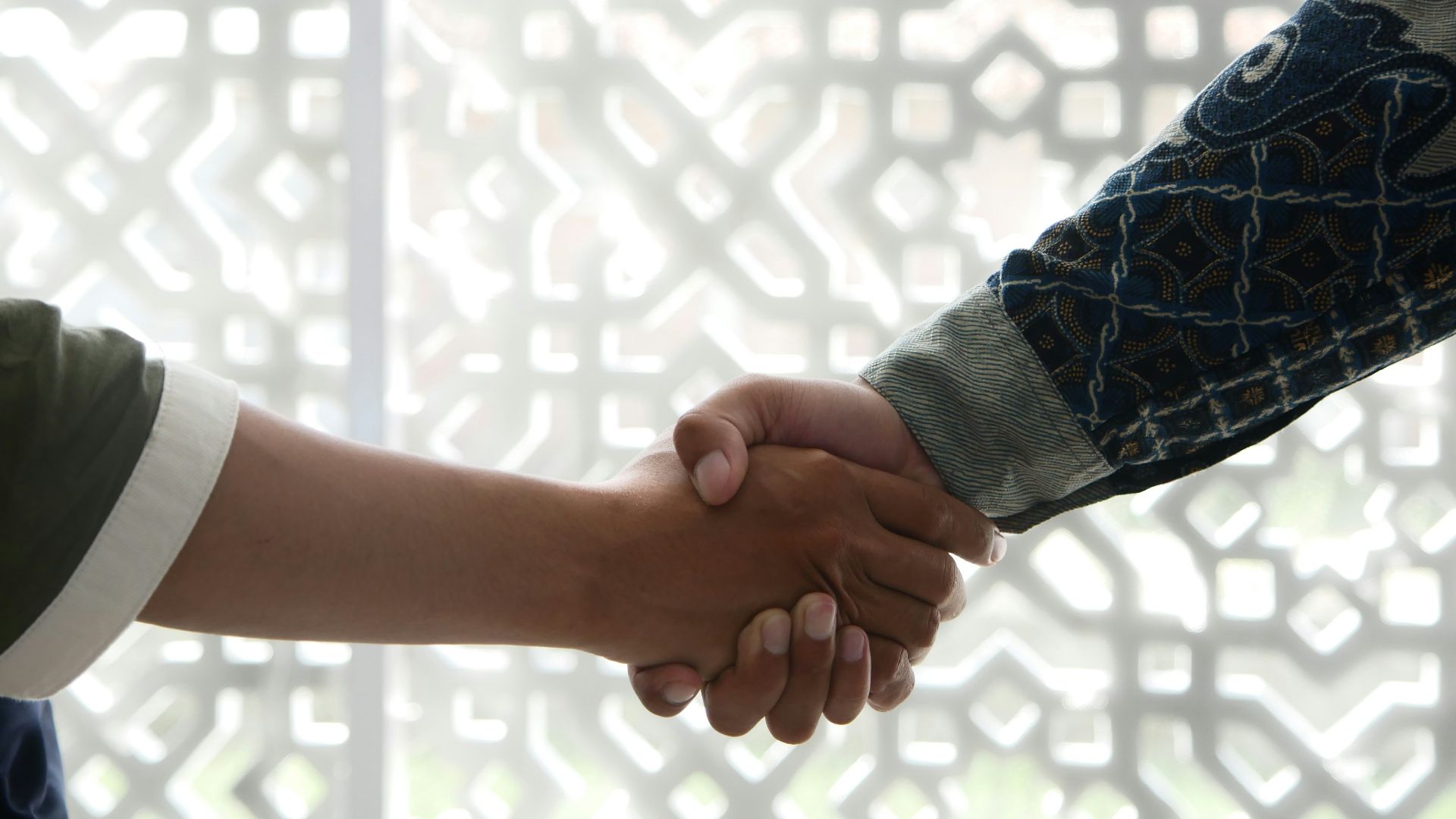 a close up of two people shaking hands