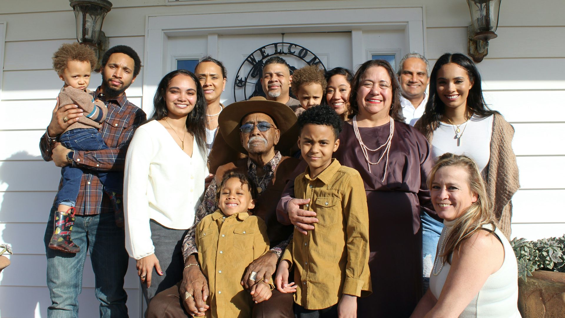 group of people standing near white building