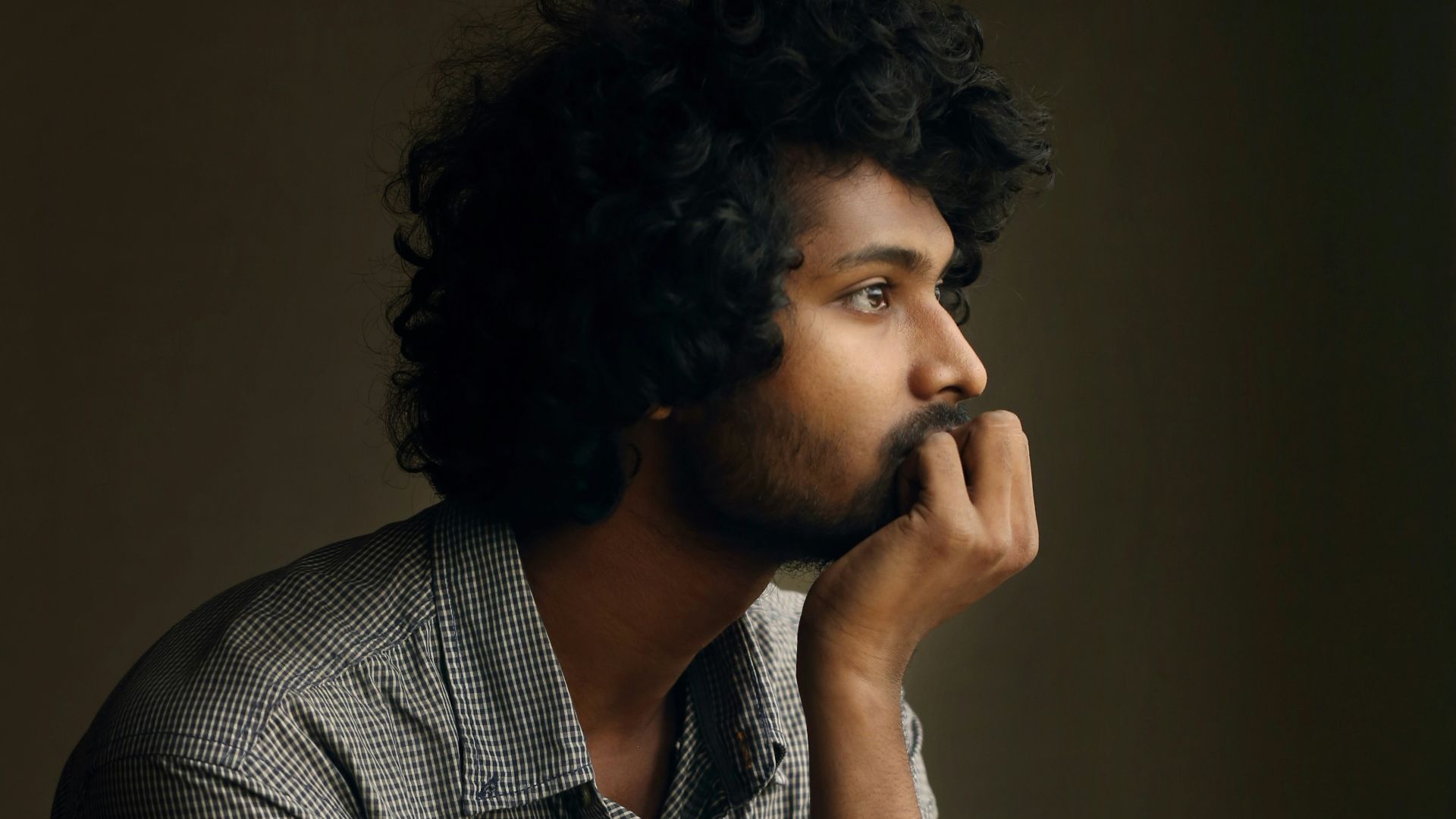 man in gray and white checkered dress shirt
