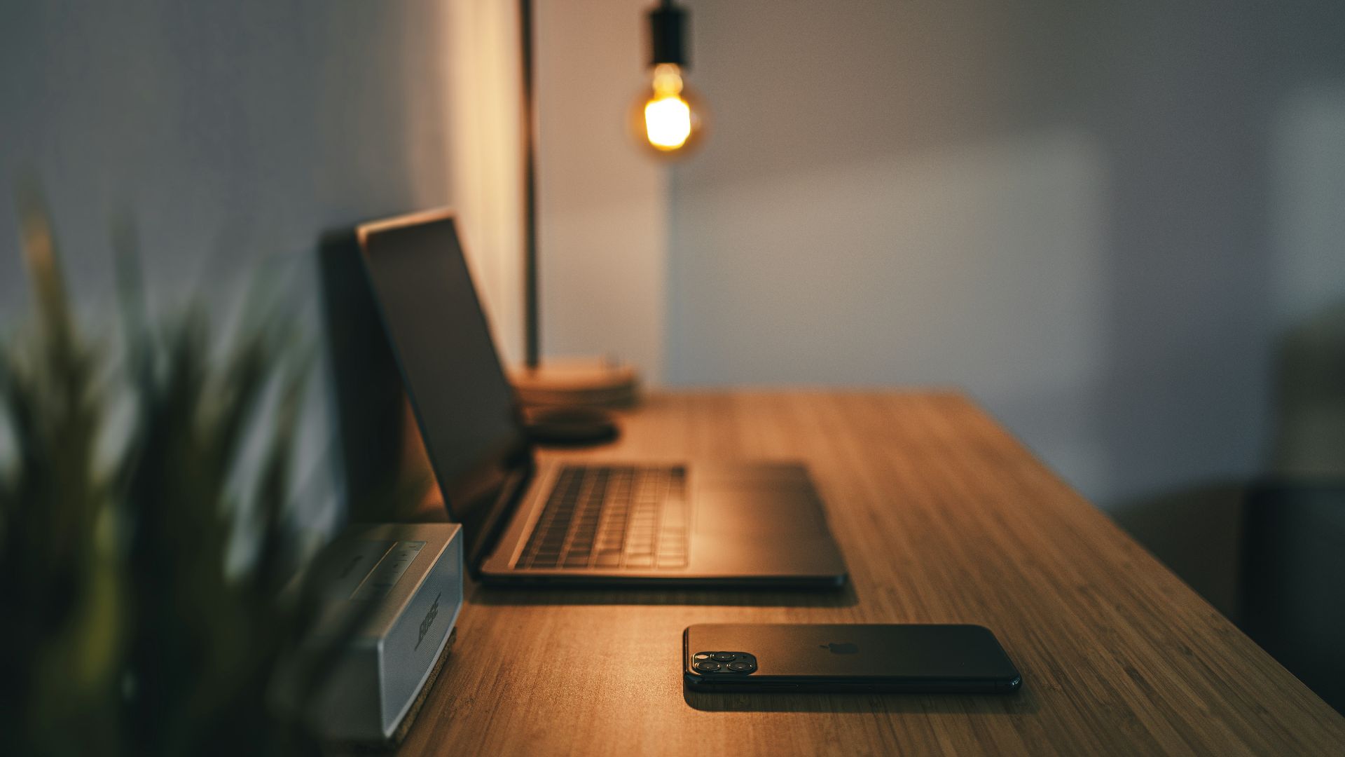 black laptop computer on brown wooden table