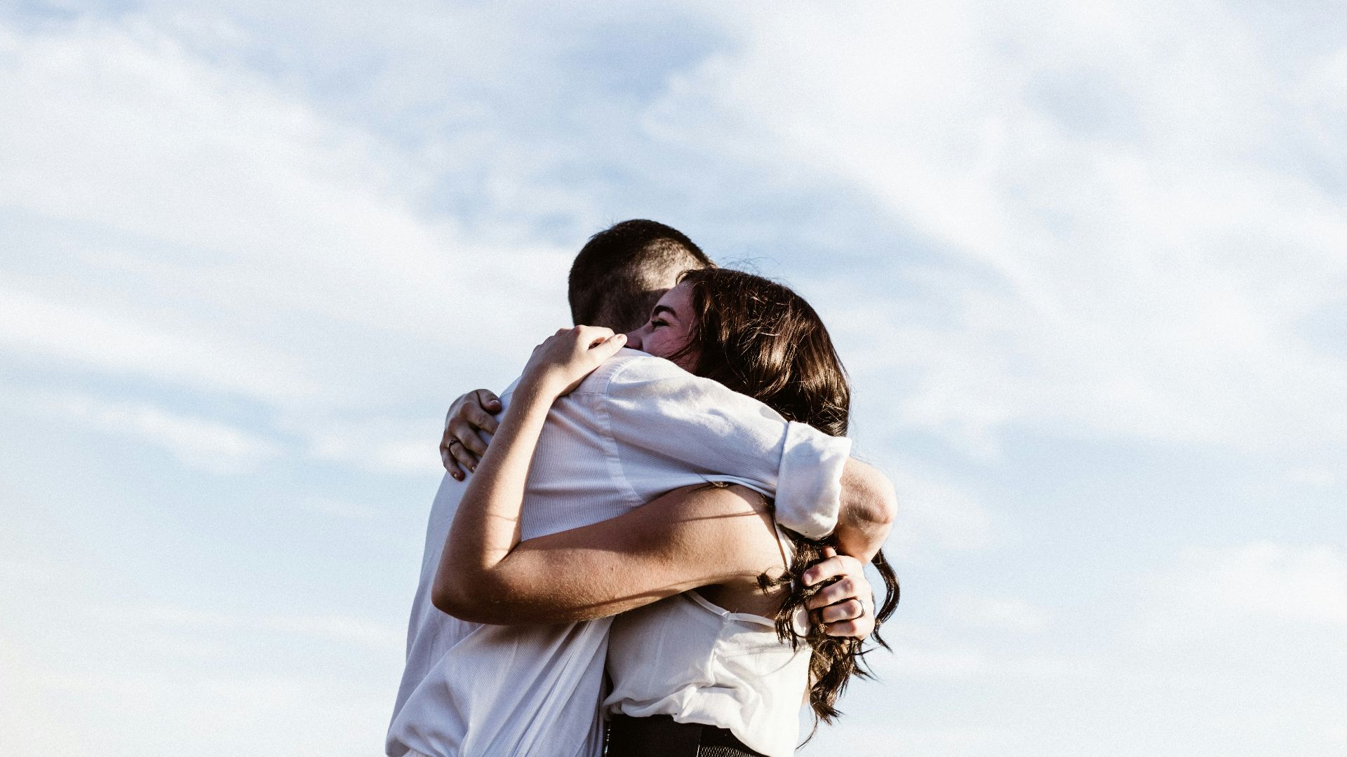 man and woman hugging each other photography