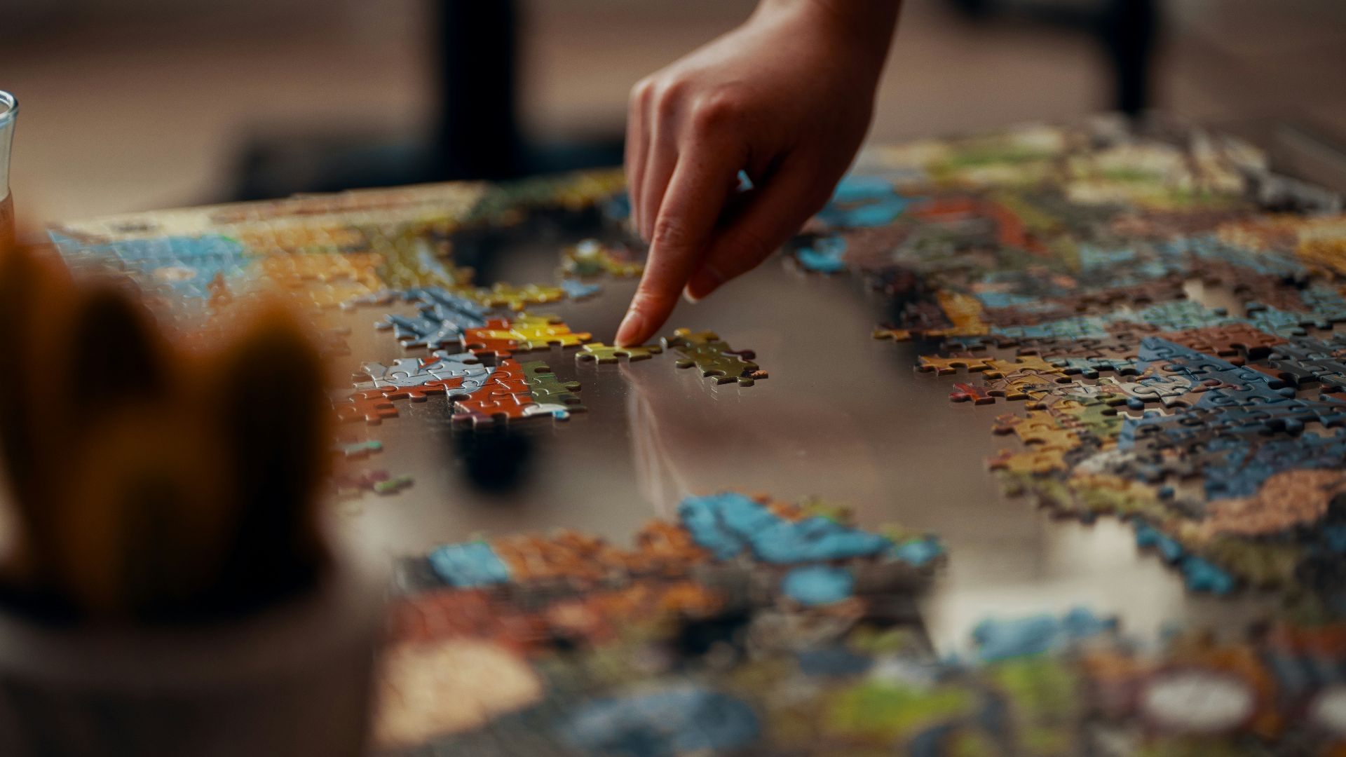 person holding jigsaw puzzle piece