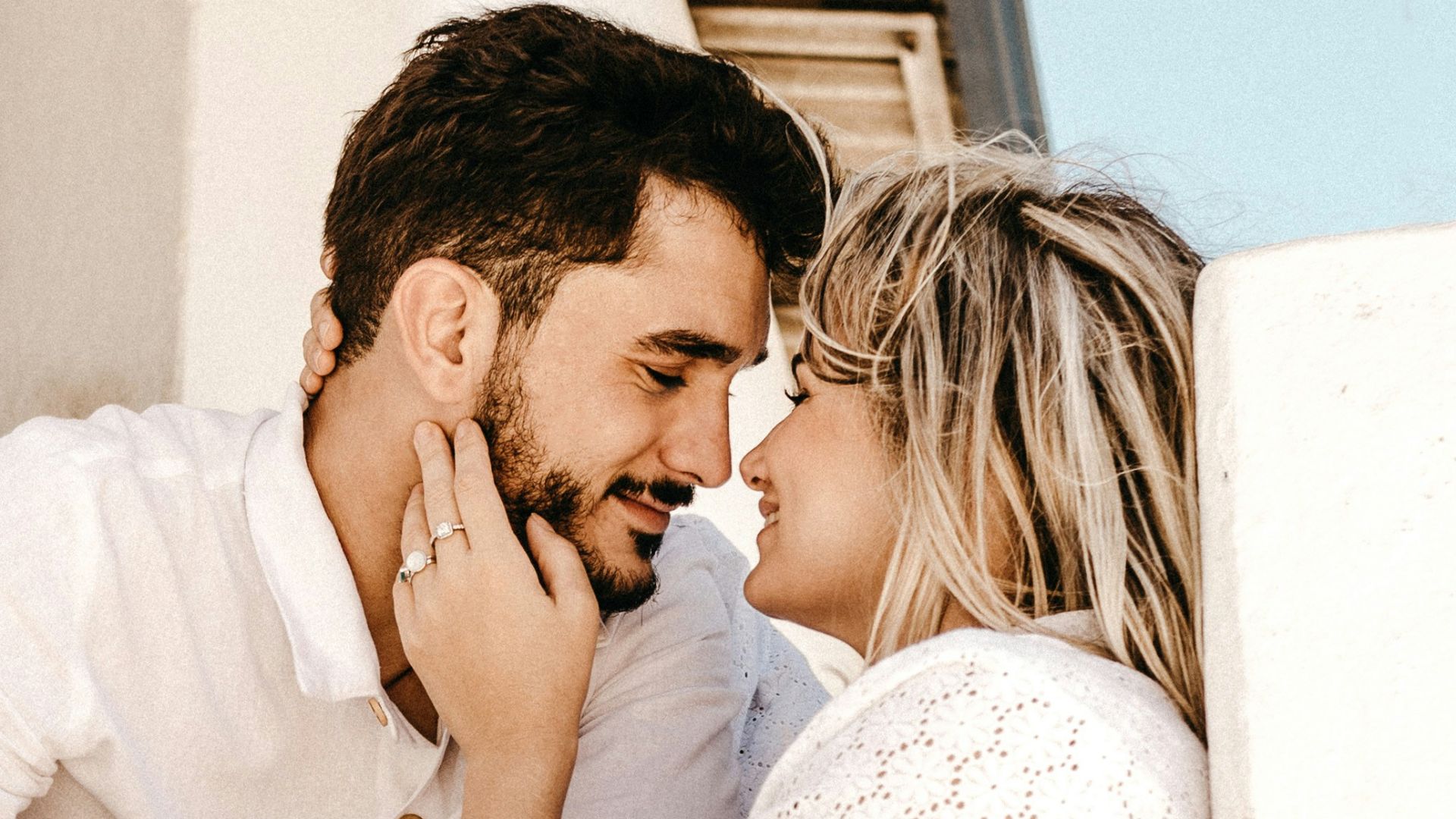 smiling man and woman about to kiss
