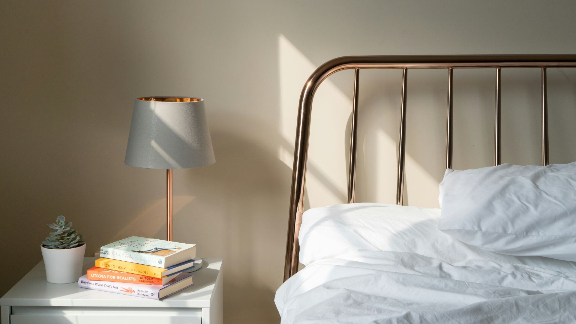 table lamp on white wooden nightstand beside bed