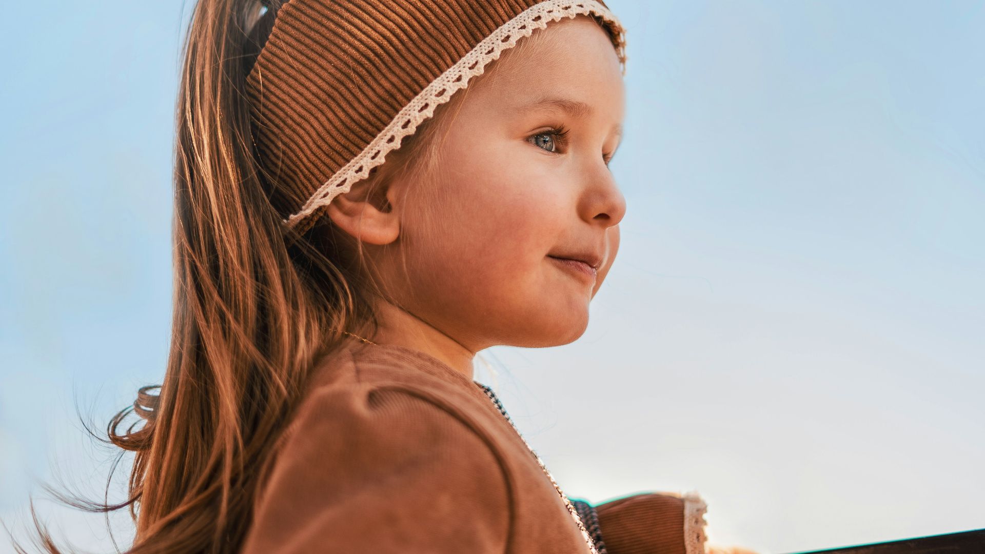 girl in brown jacket and black and white plaid skirt