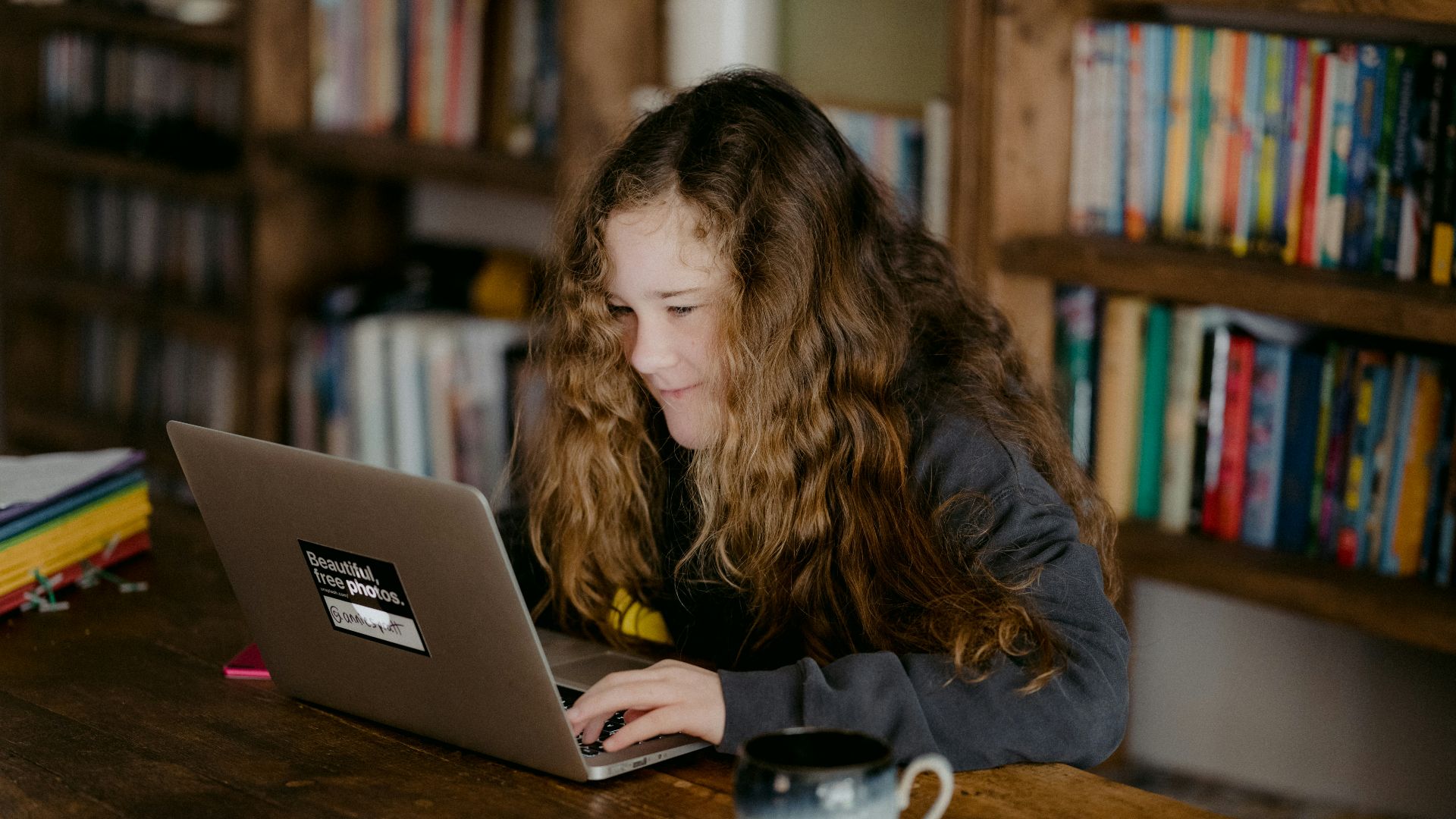 woman in black jacket using macbook pro