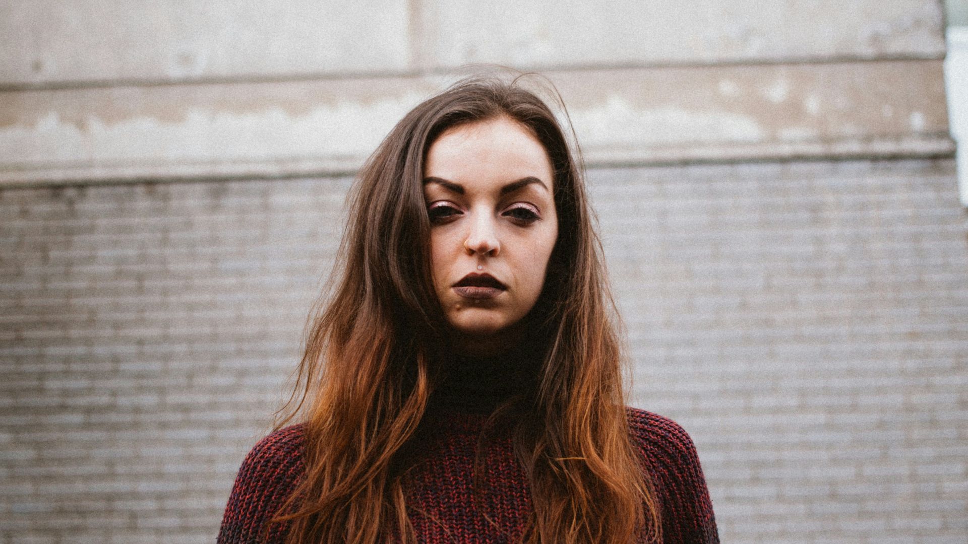 woman standing near brown building