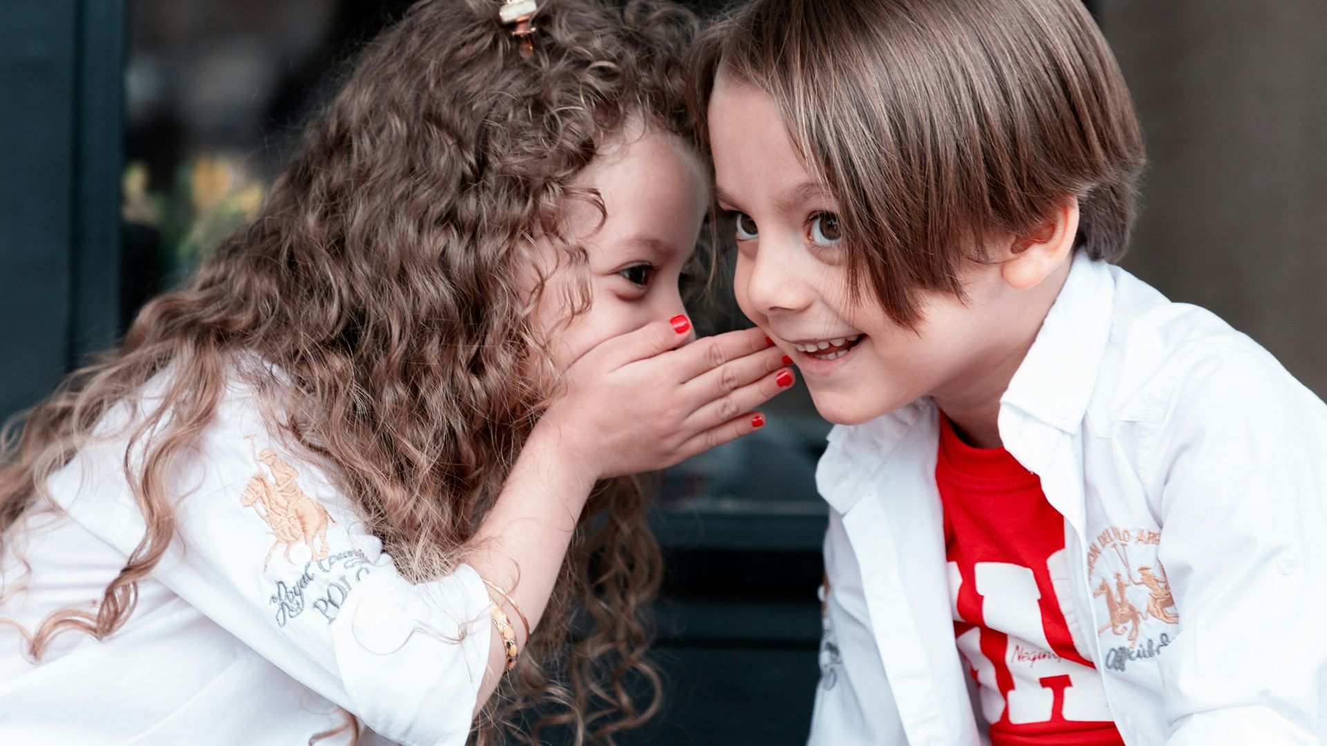 woman in white long sleeve shirt kissing girl in white long sleeve shirt