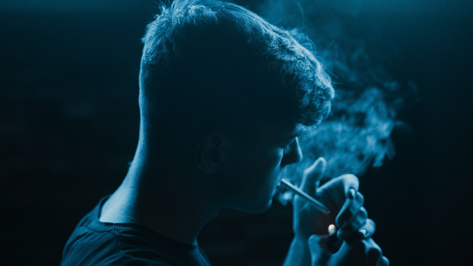 man standing and smoking