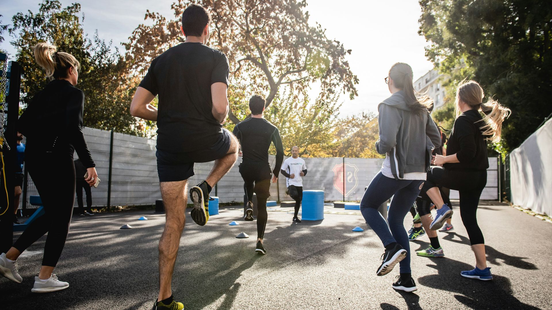 man in black t-shirt and black shorts running on road during daytime