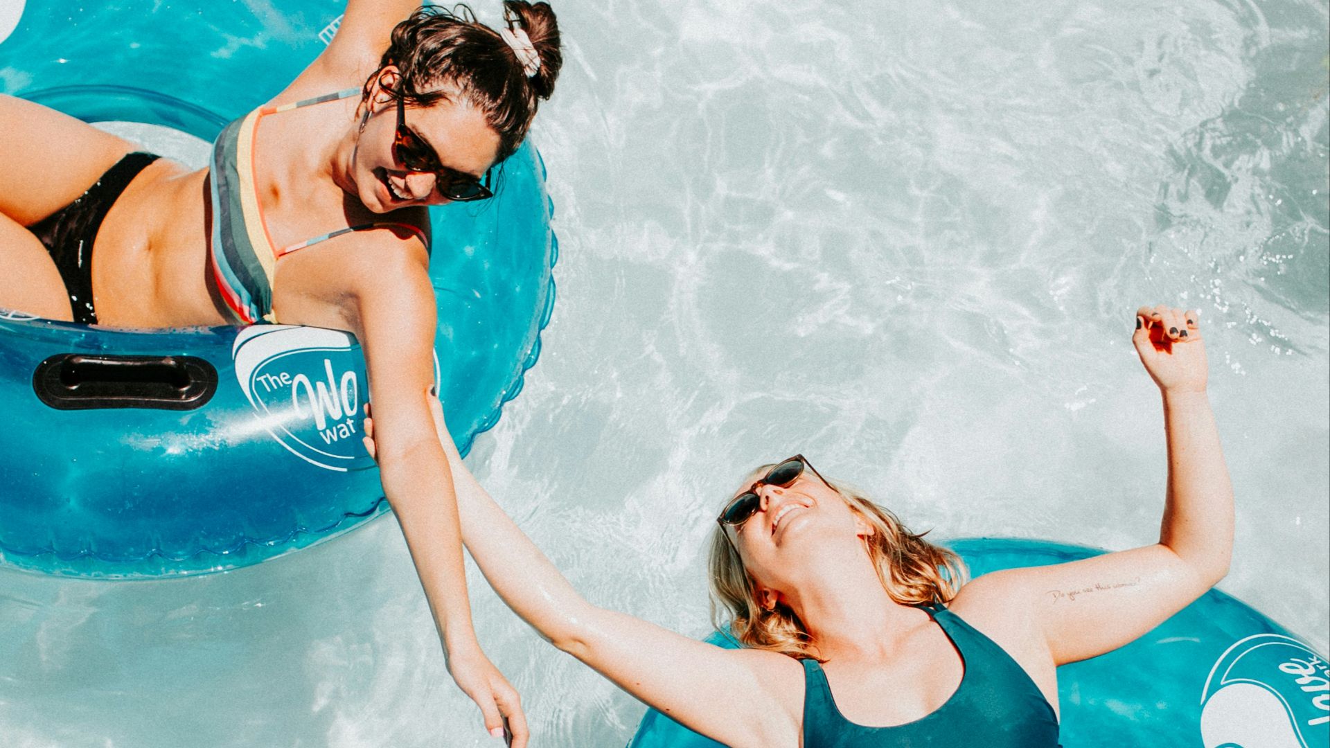 women on inflatable rings