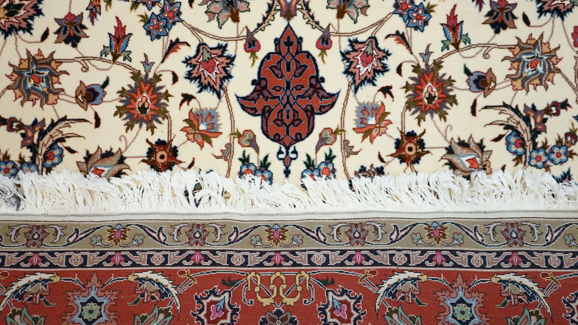 an oriental rug with a tassel on top of it