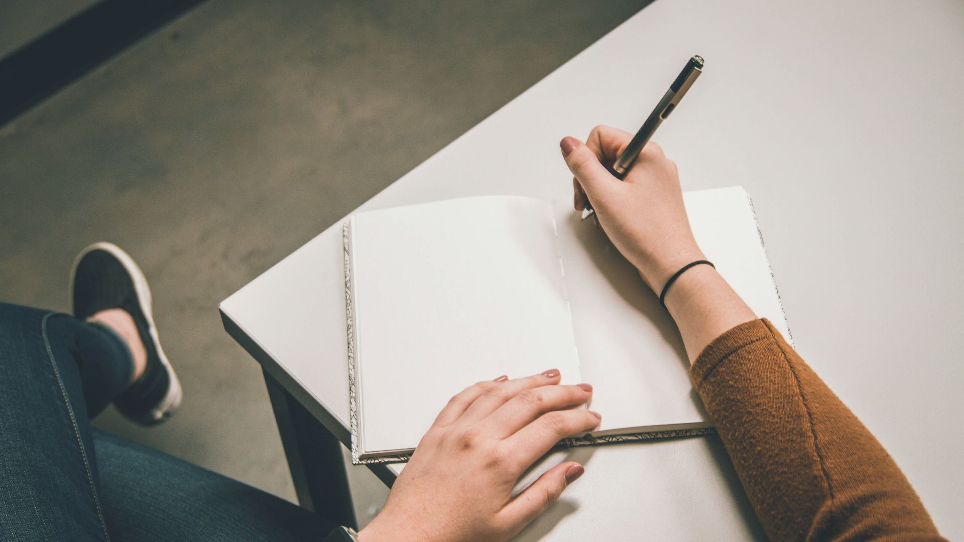 person writing on white paper