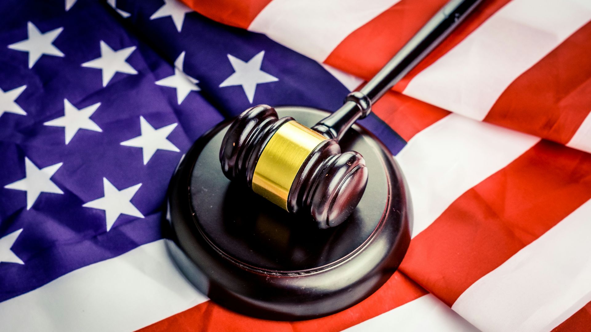 a judge's gavel on top of a flag
