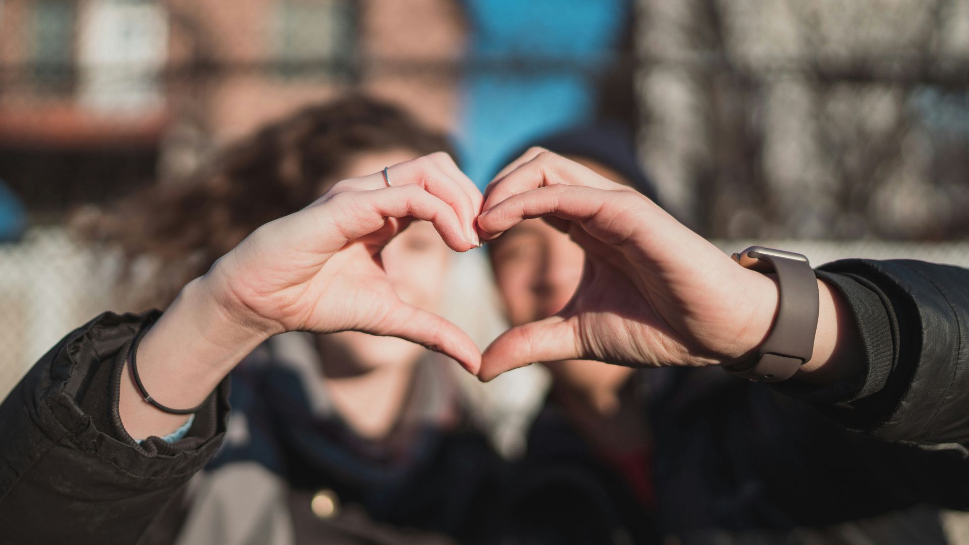 two person combine hand forming a heart hand gesture