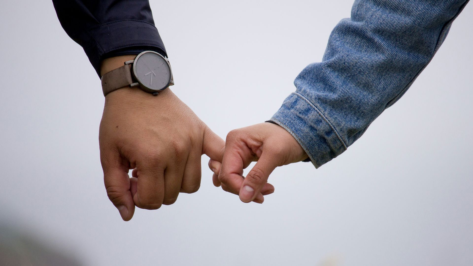 man and woman holding hands together