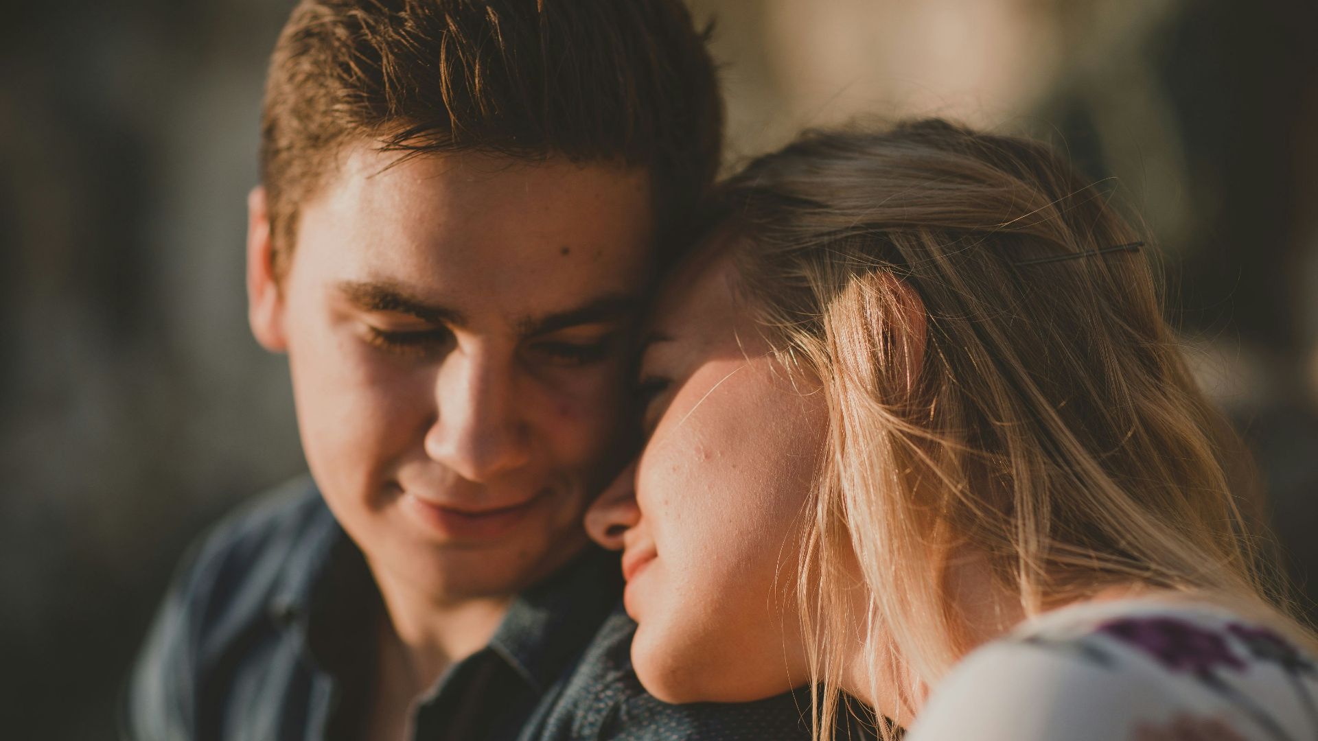 woman leaning on man's shoulder