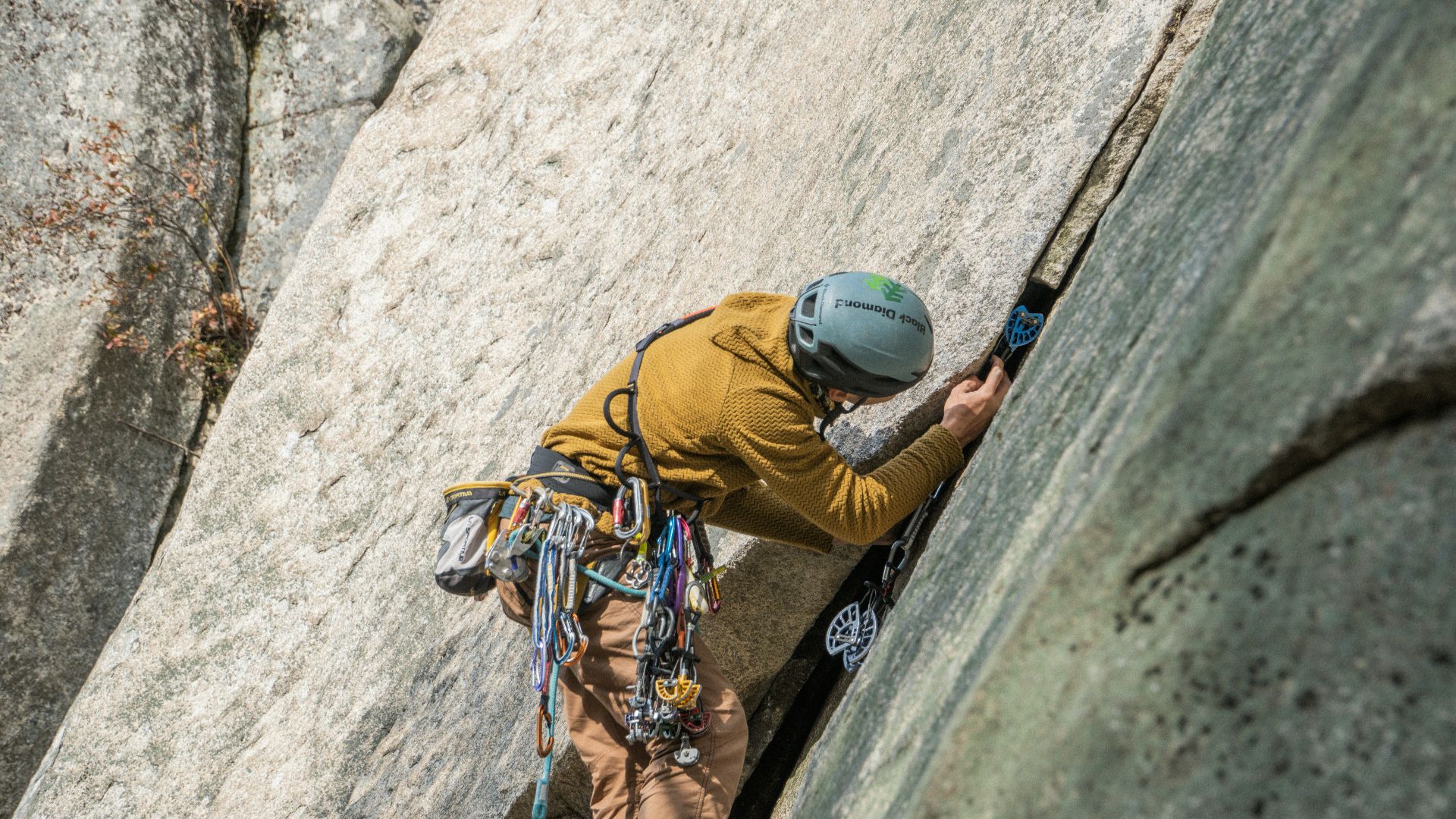 a man climbing up the side of a mountain