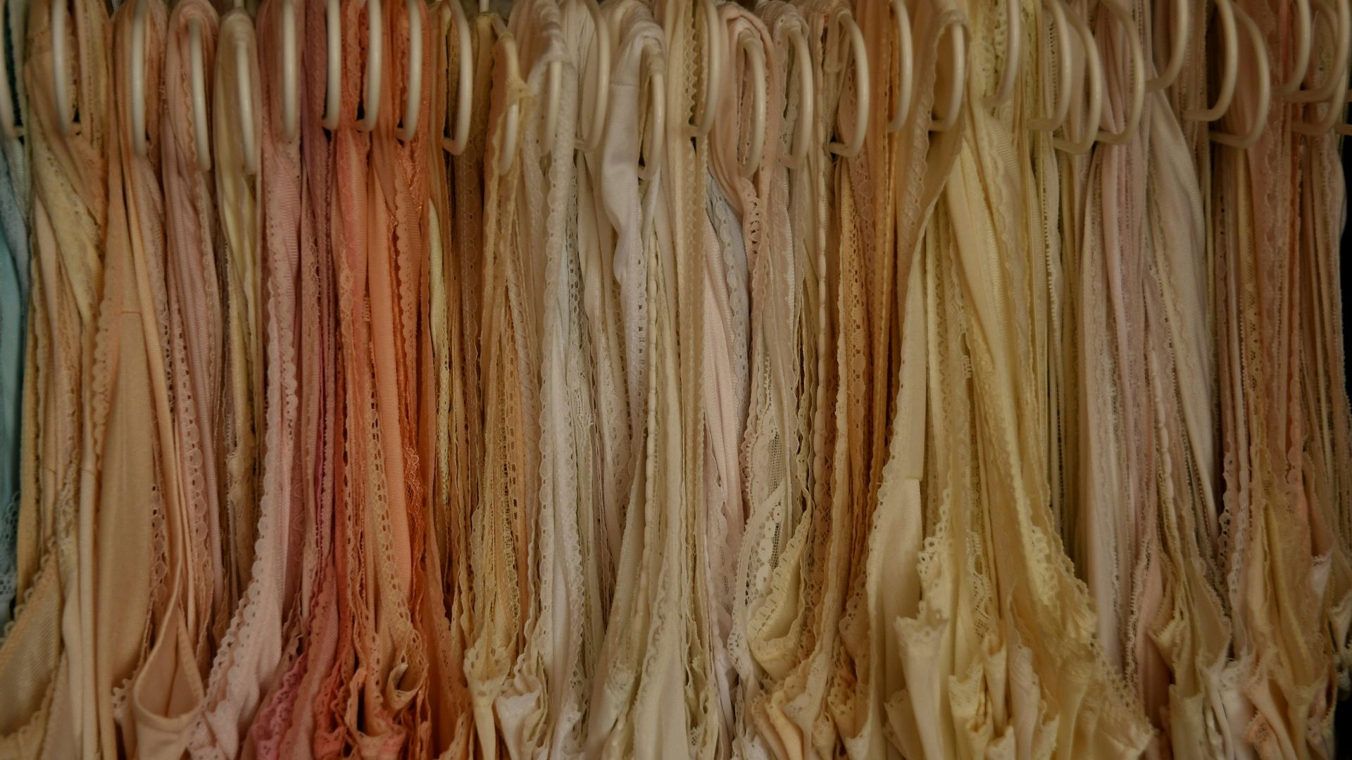 a bunch of clothes hanging on a rack