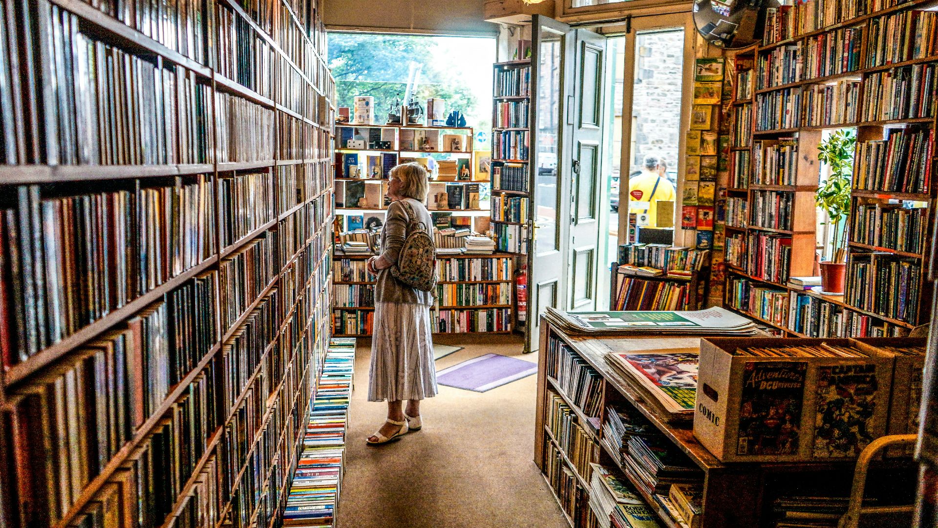 woman inside library looking at books