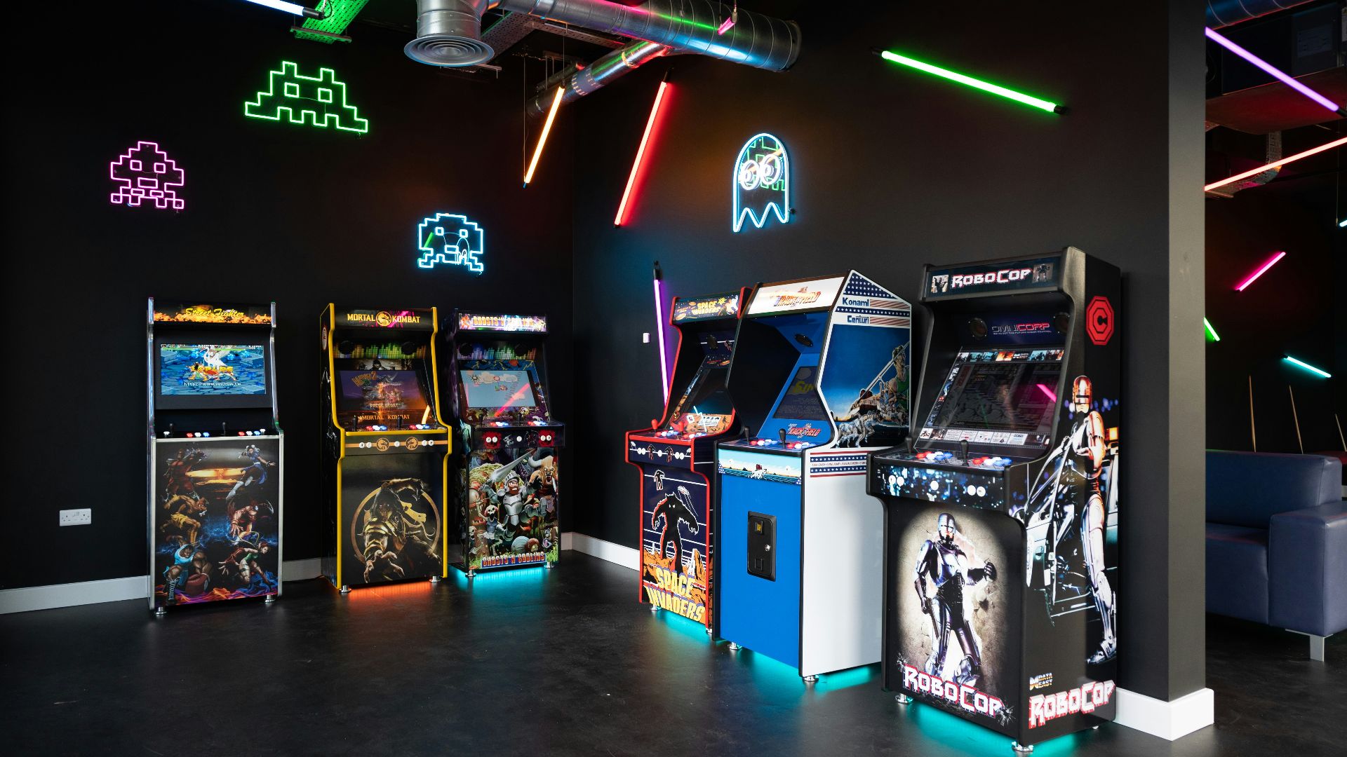 a room filled with arcade machines and neon lights