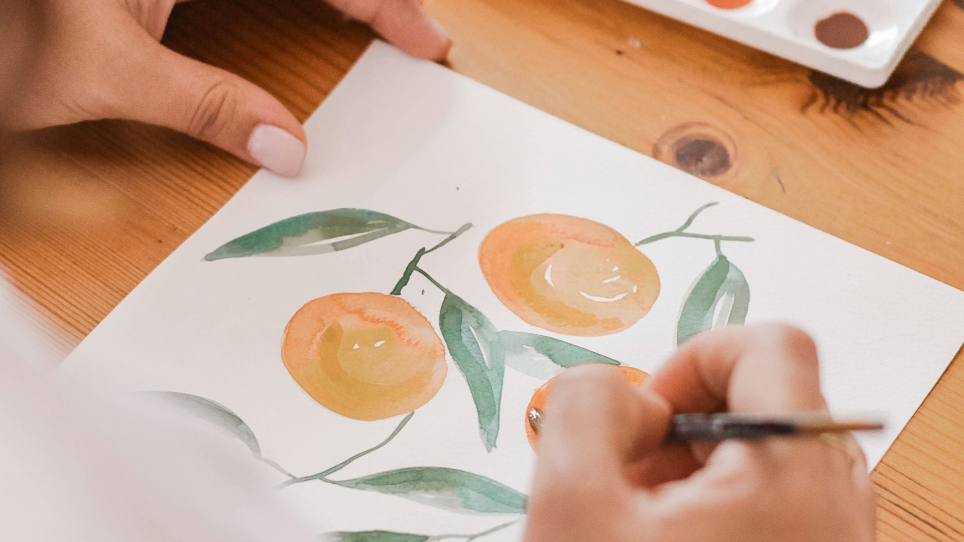 person painting a orange fruits