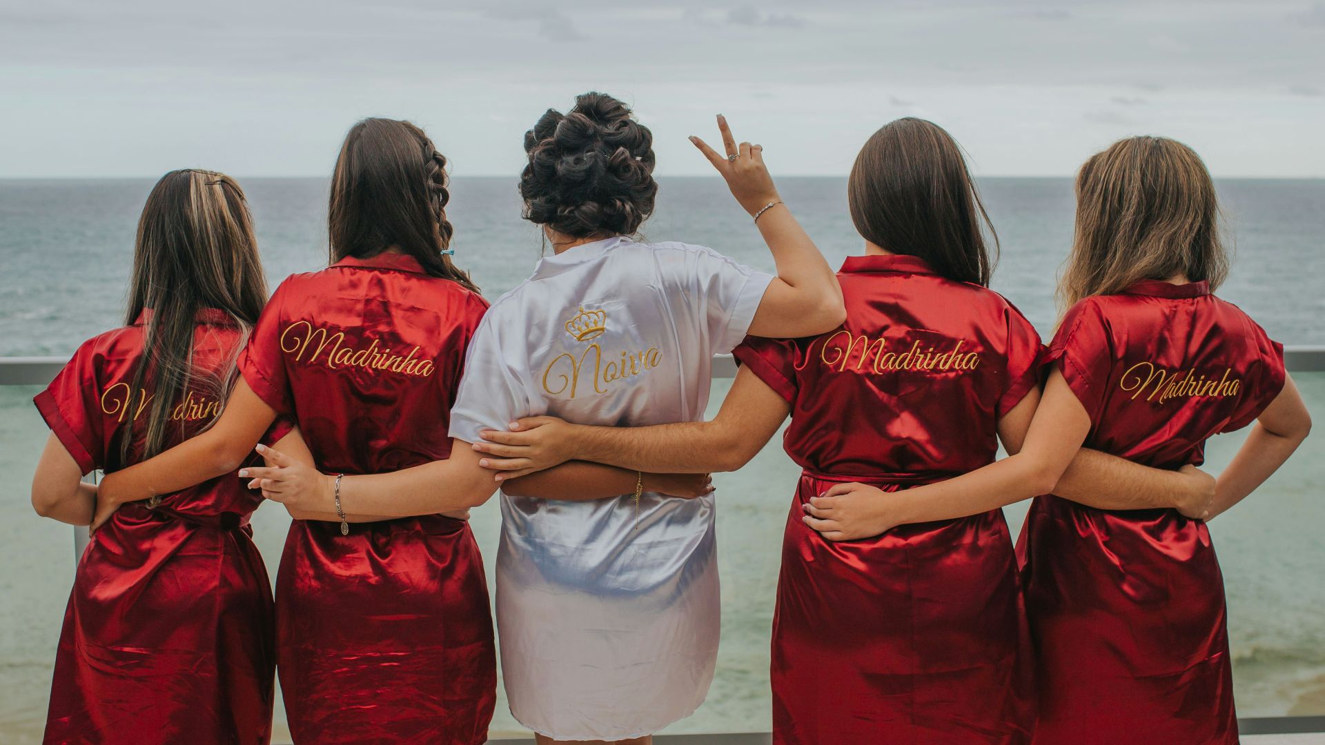 brides and bridesmaid looking at the back