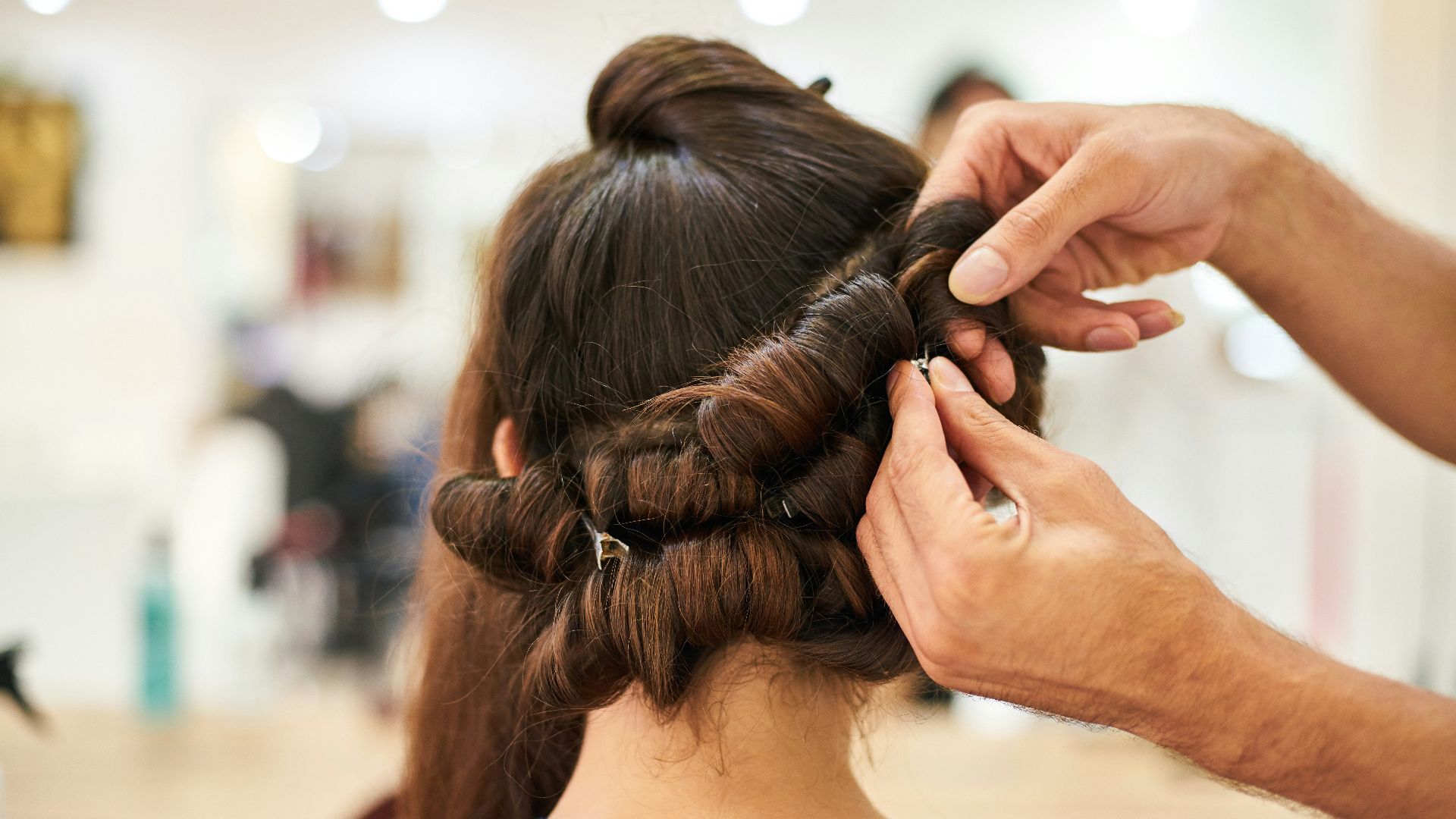 woman in blue shirt holding her hair