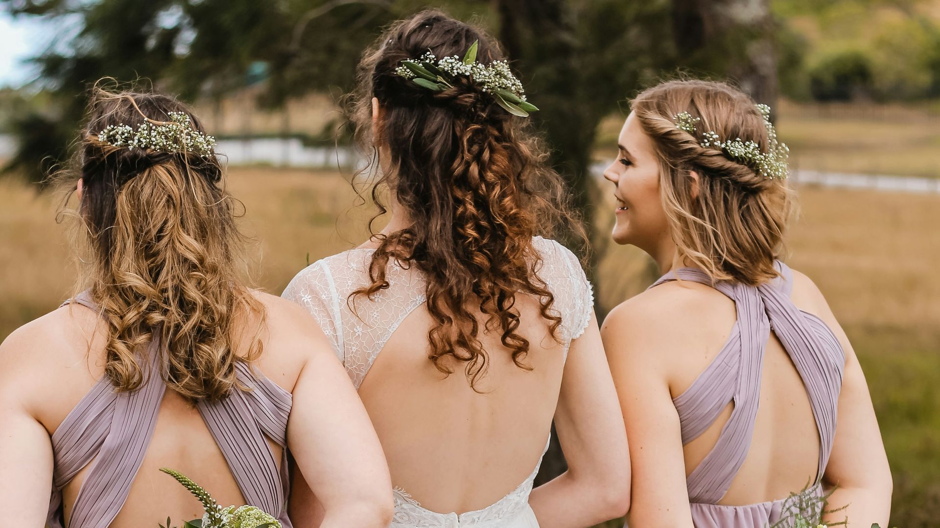 three women hiding flower bouquets