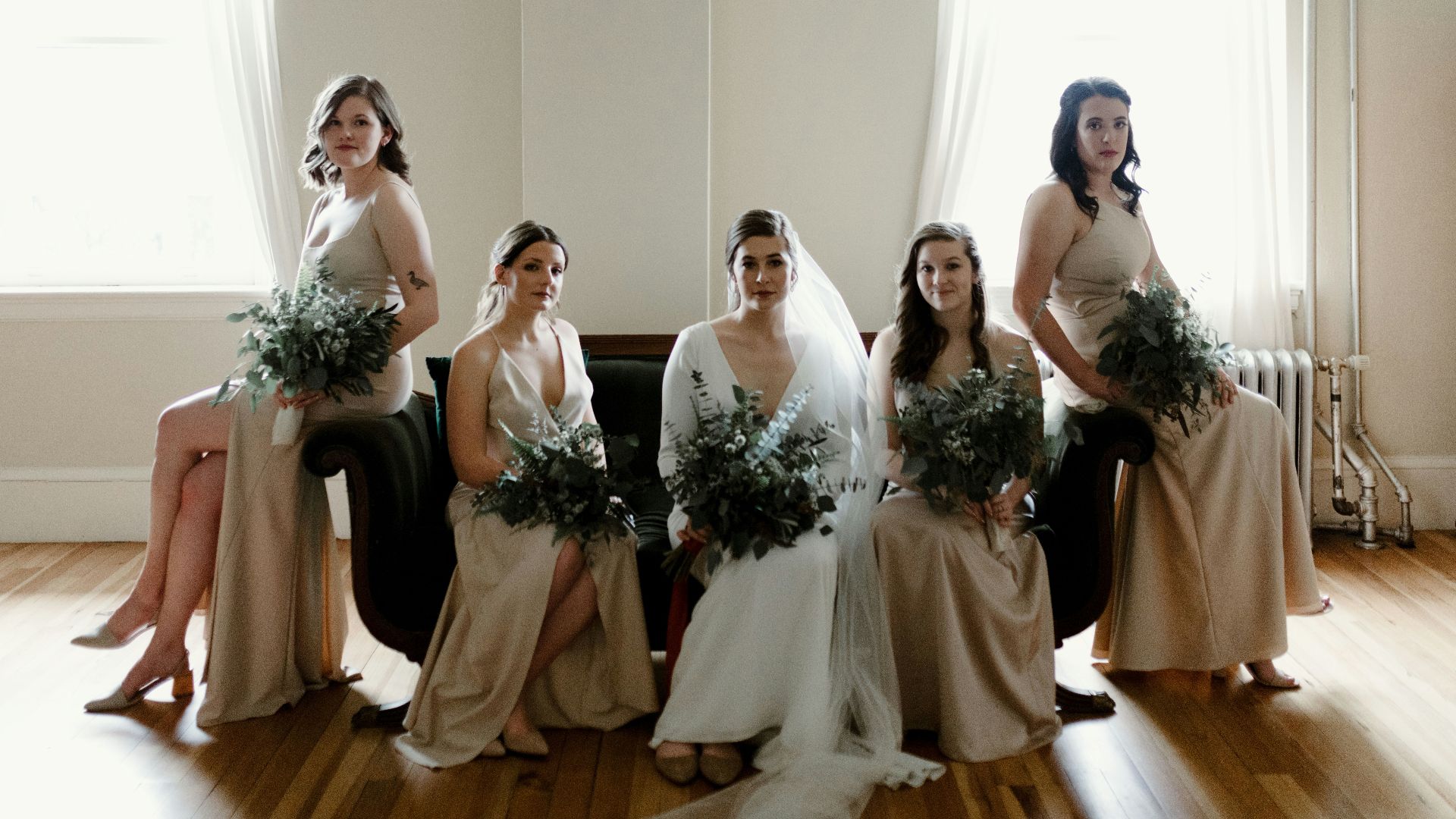 woman in white wedding gown holding bouquet of flowers