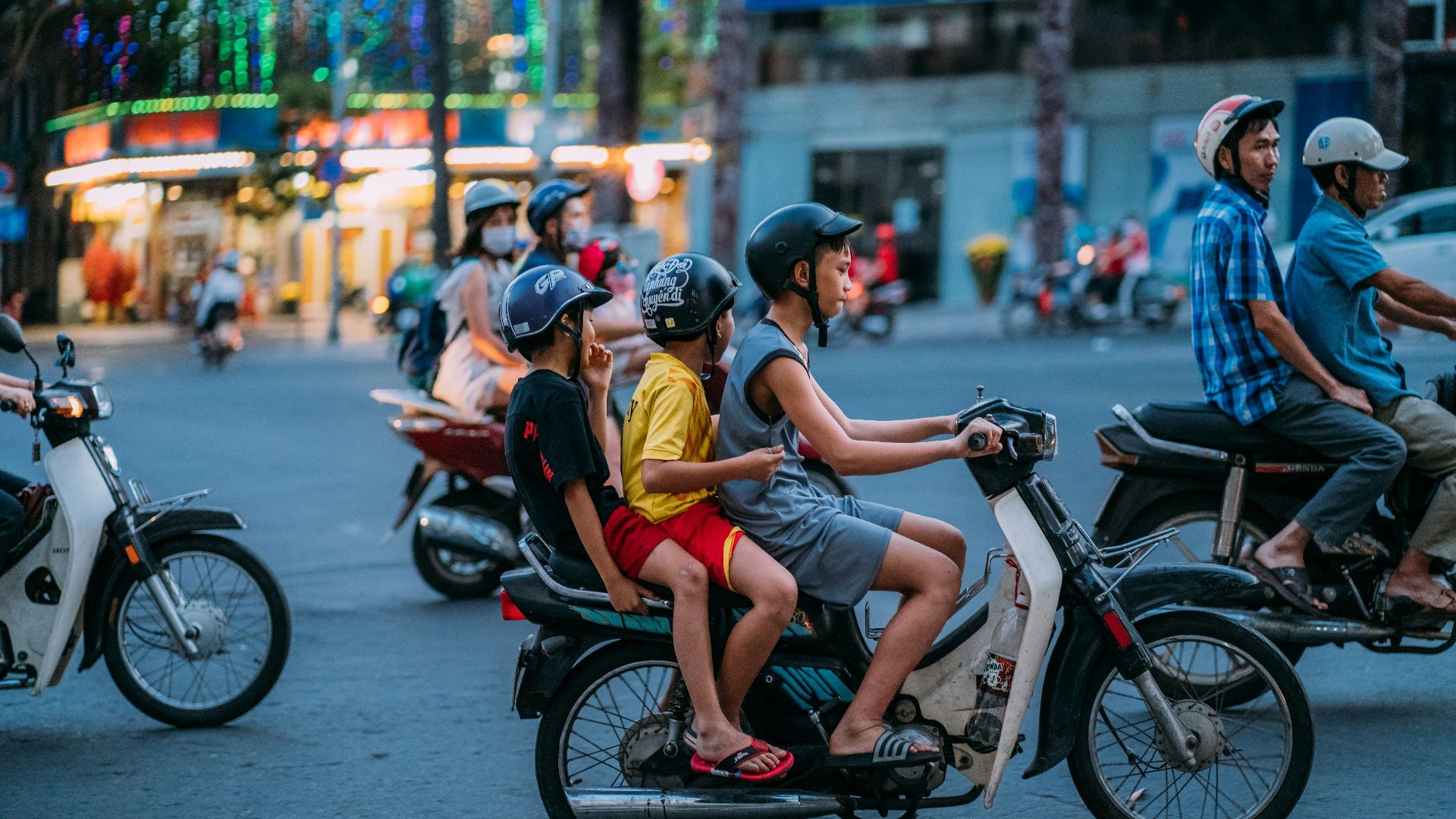 man in yellow shirt riding motorcycle with woman in yellow shirt