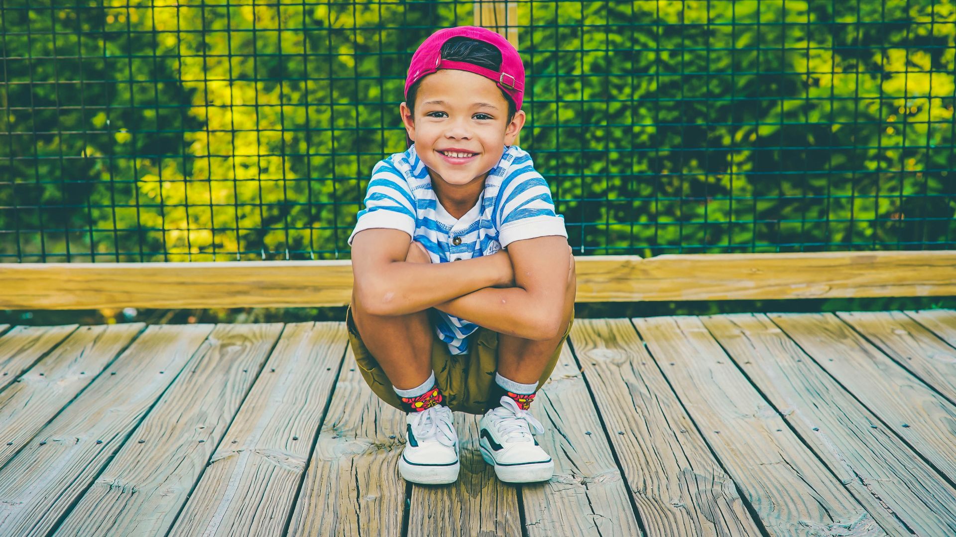 boy on wooden porch near railing