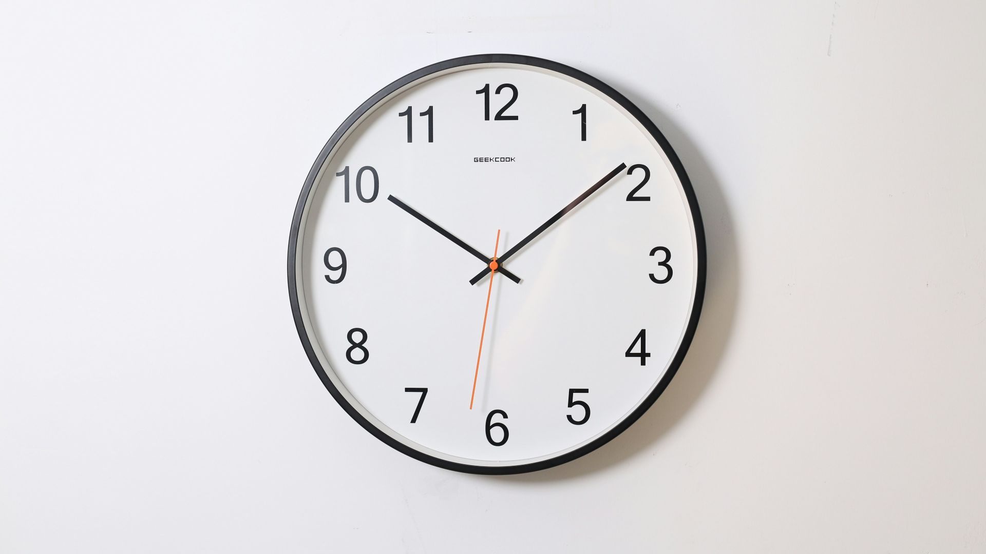 round analog wall clock pointing at 10:09