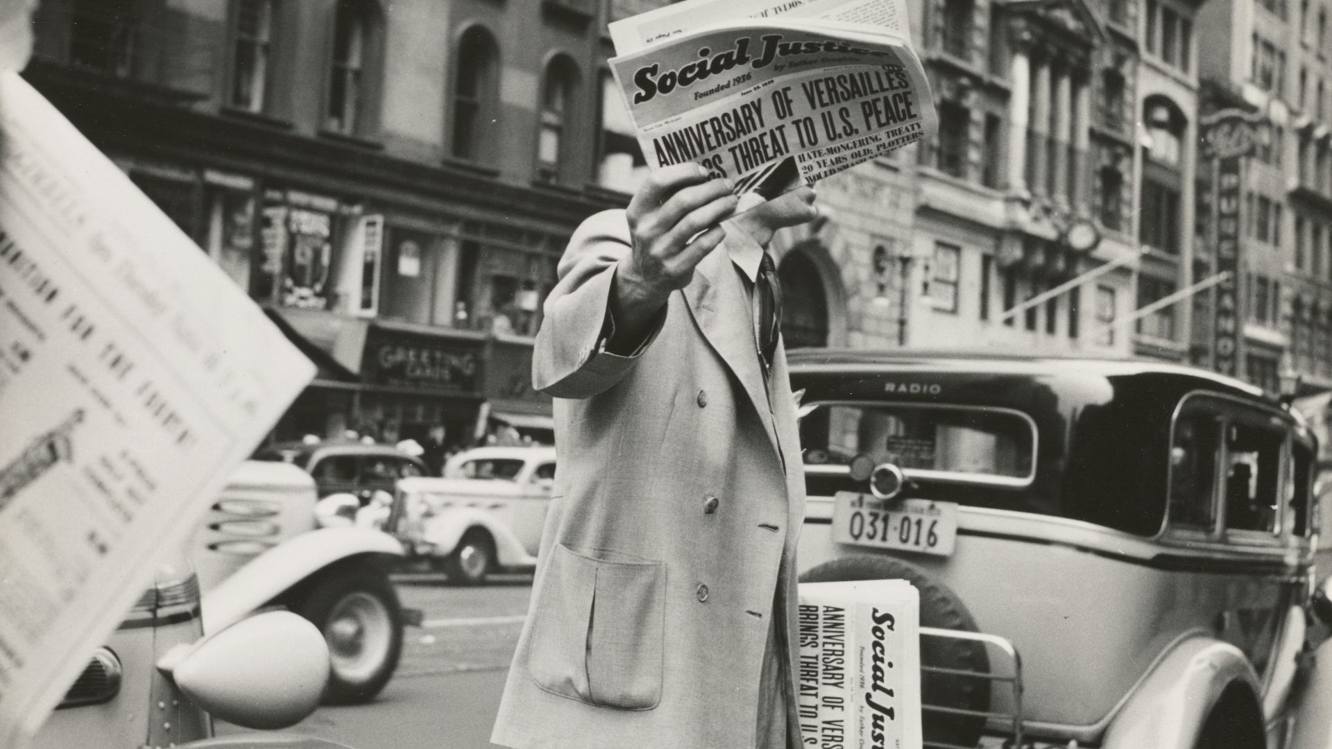 grayscale photography unknown person holding newspaper