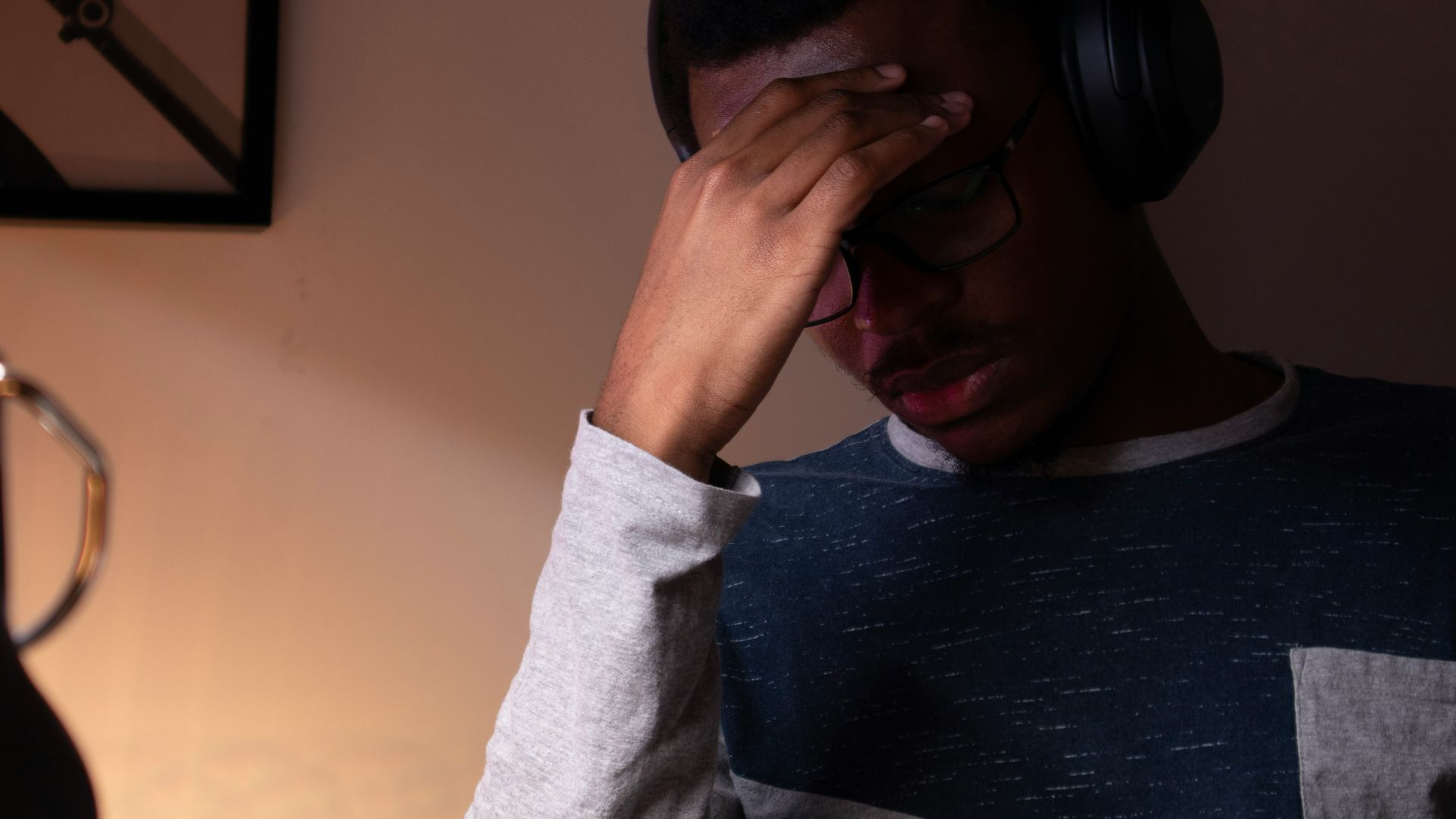woman in gray sweater covering her face