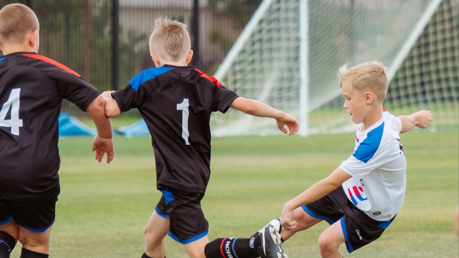 2 men playing soccer during daytime