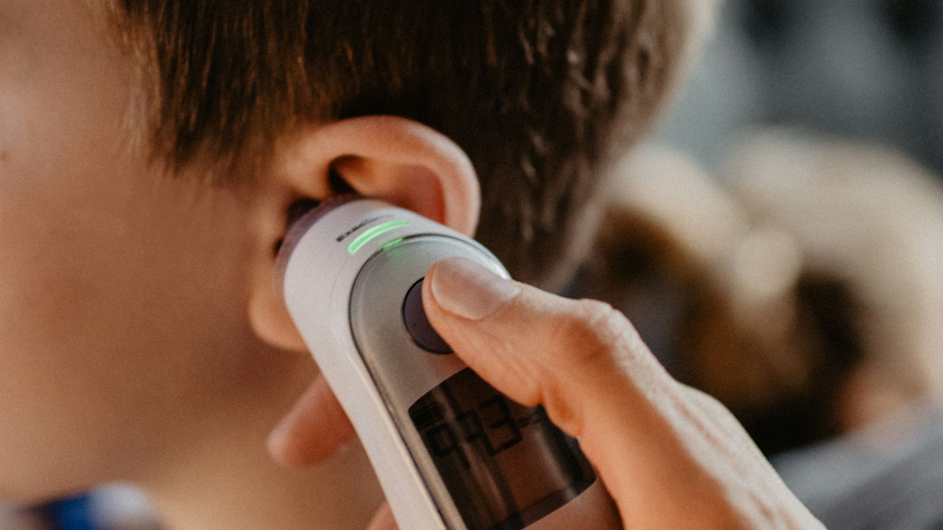 man holding white and gray bottle