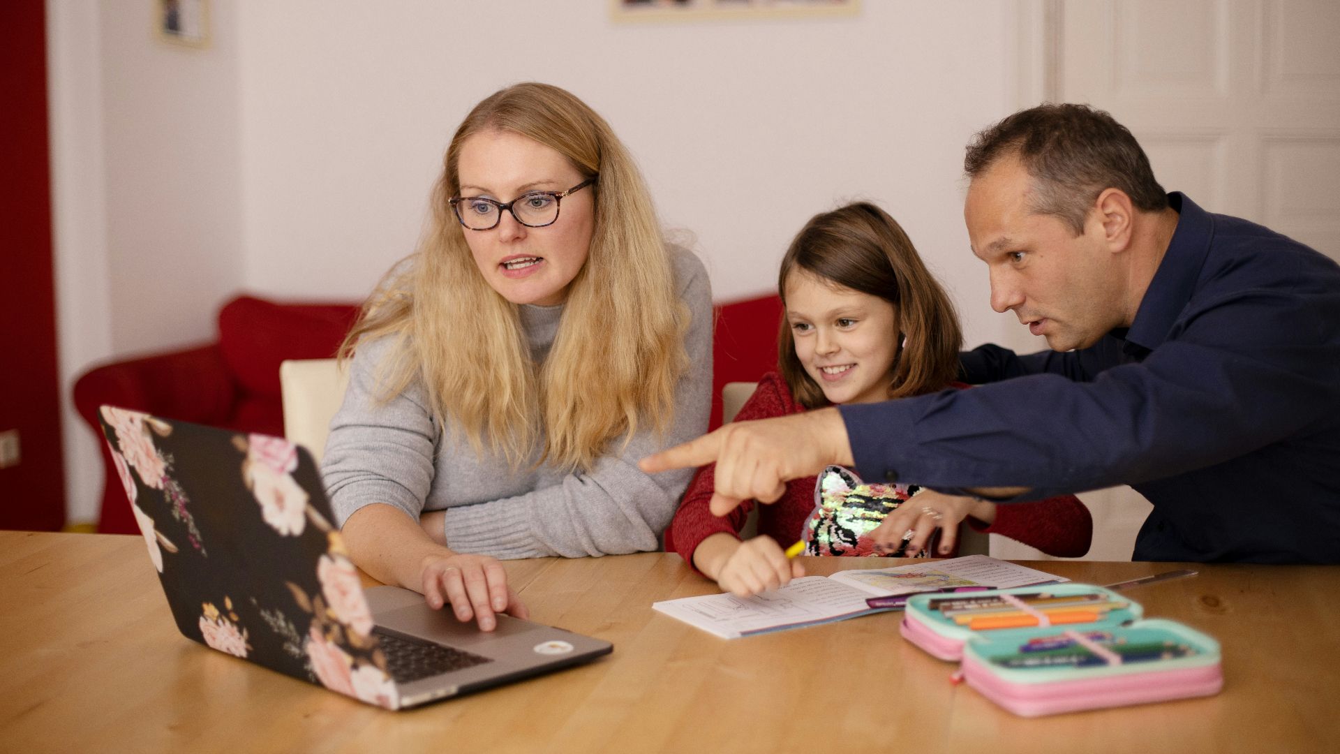 woman in gray long sleeve shirt sitting beside boy in blue sweater