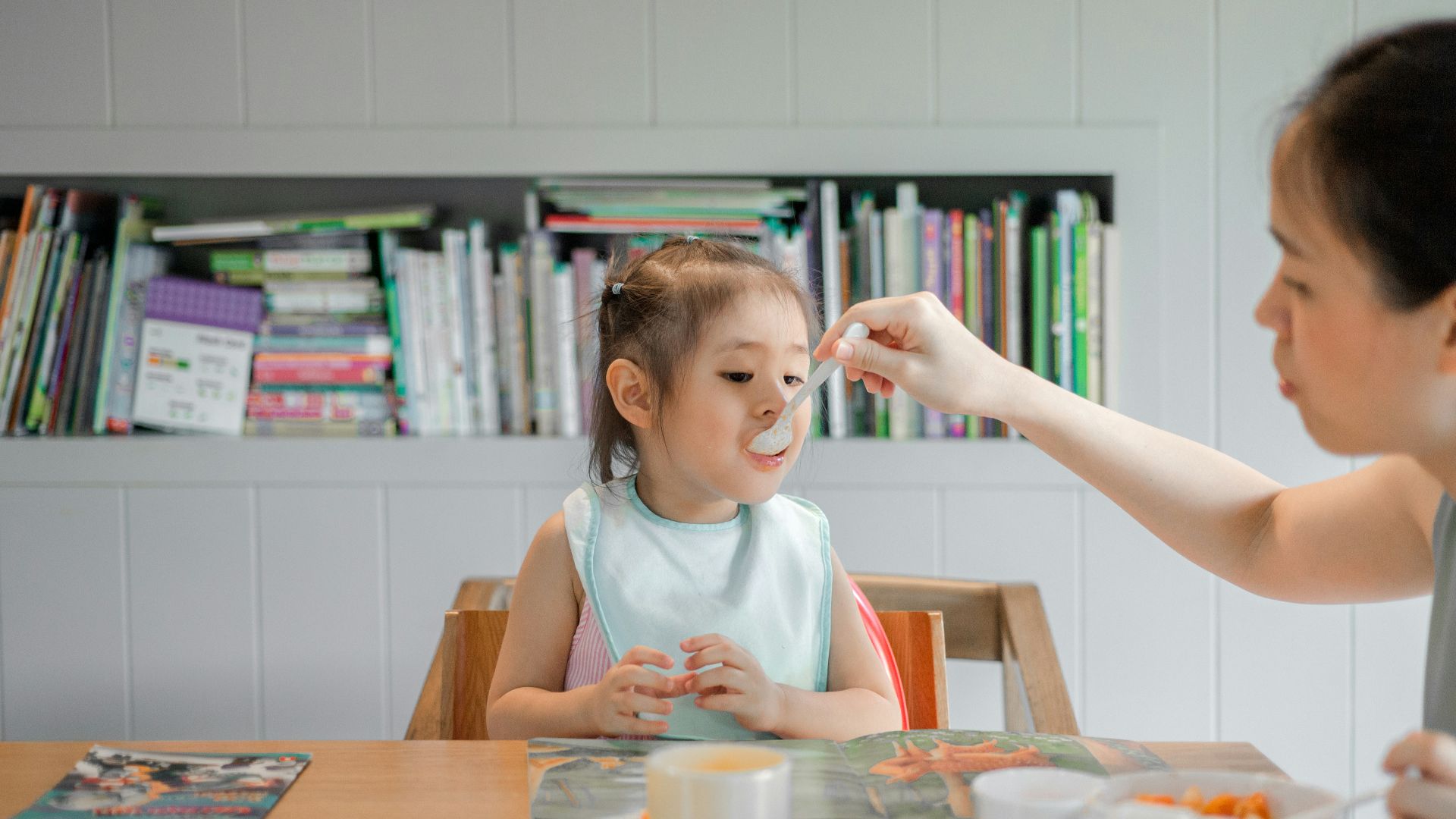 woman holding white plastic spoon